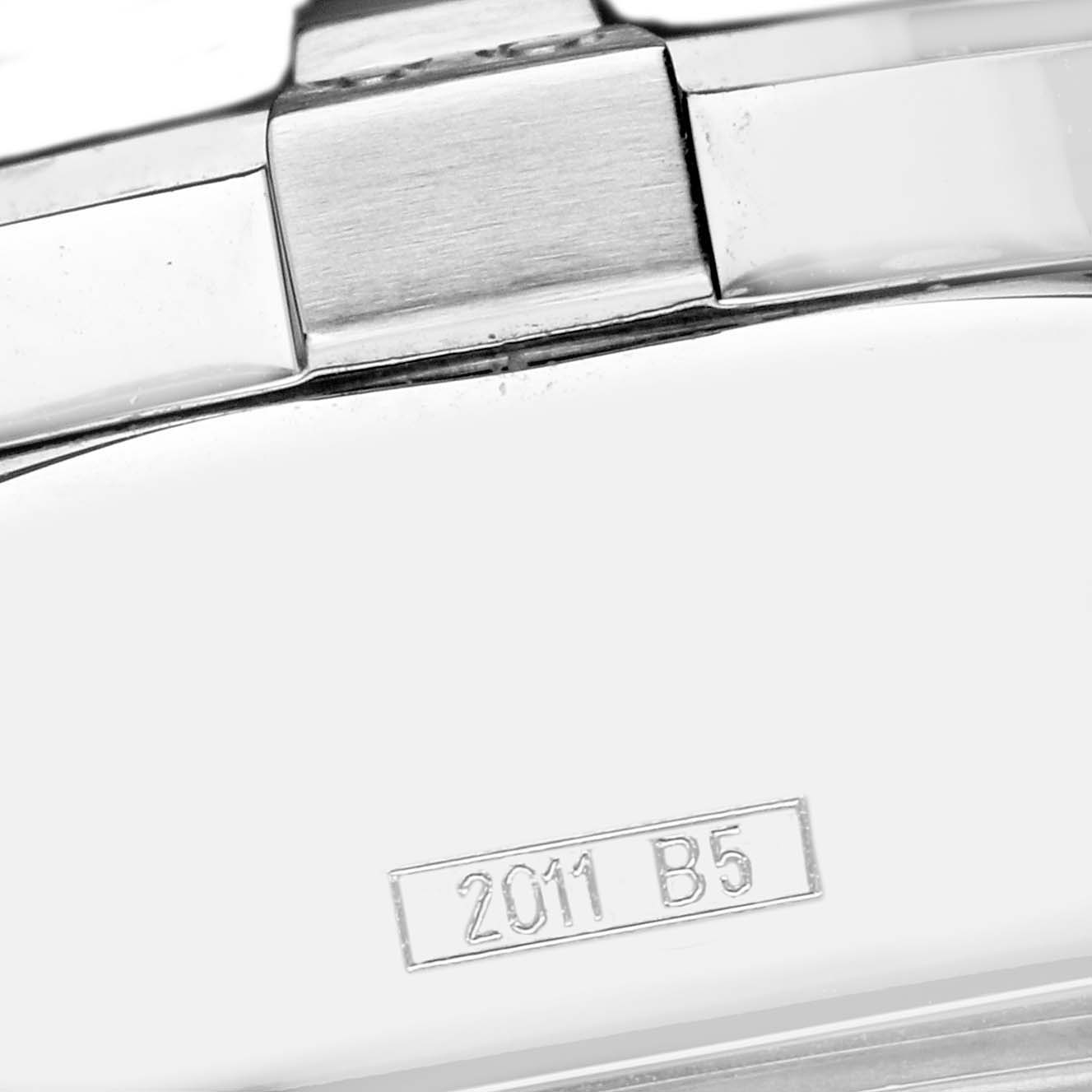 The image shows a close-up of the clasp and part of the bracelet of a Breitling Avenger A13370 Men
s Stainless Steel Black Dial watch, focusing on the metal surface and etched markings.