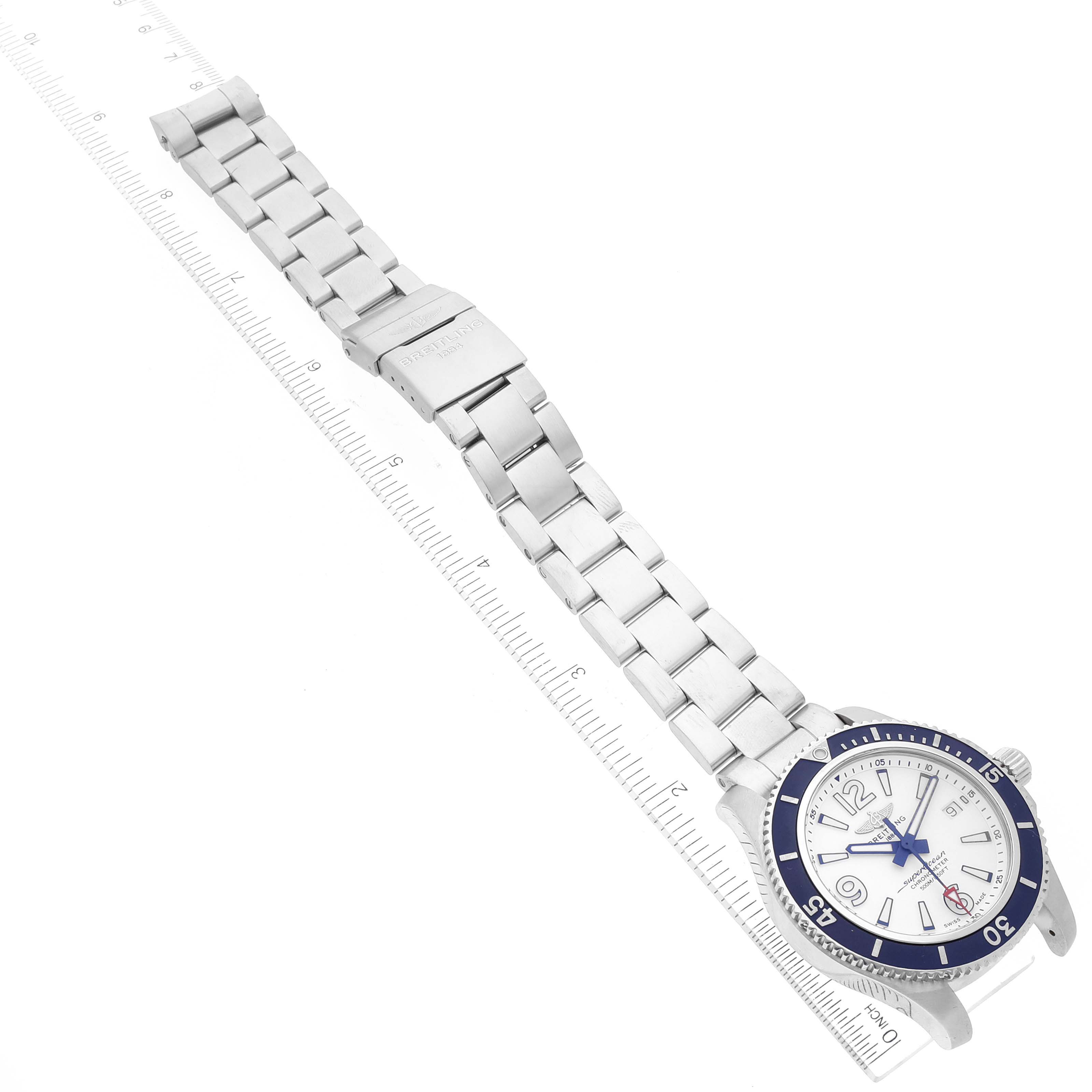 The Breitling A17366 Men's Stainless Steel White Dial A17366 Men's Stainless Steel White Dial Superocean 42 A17366 watch is shown lying flat with its full steel bracelet extended and a white dial visible.