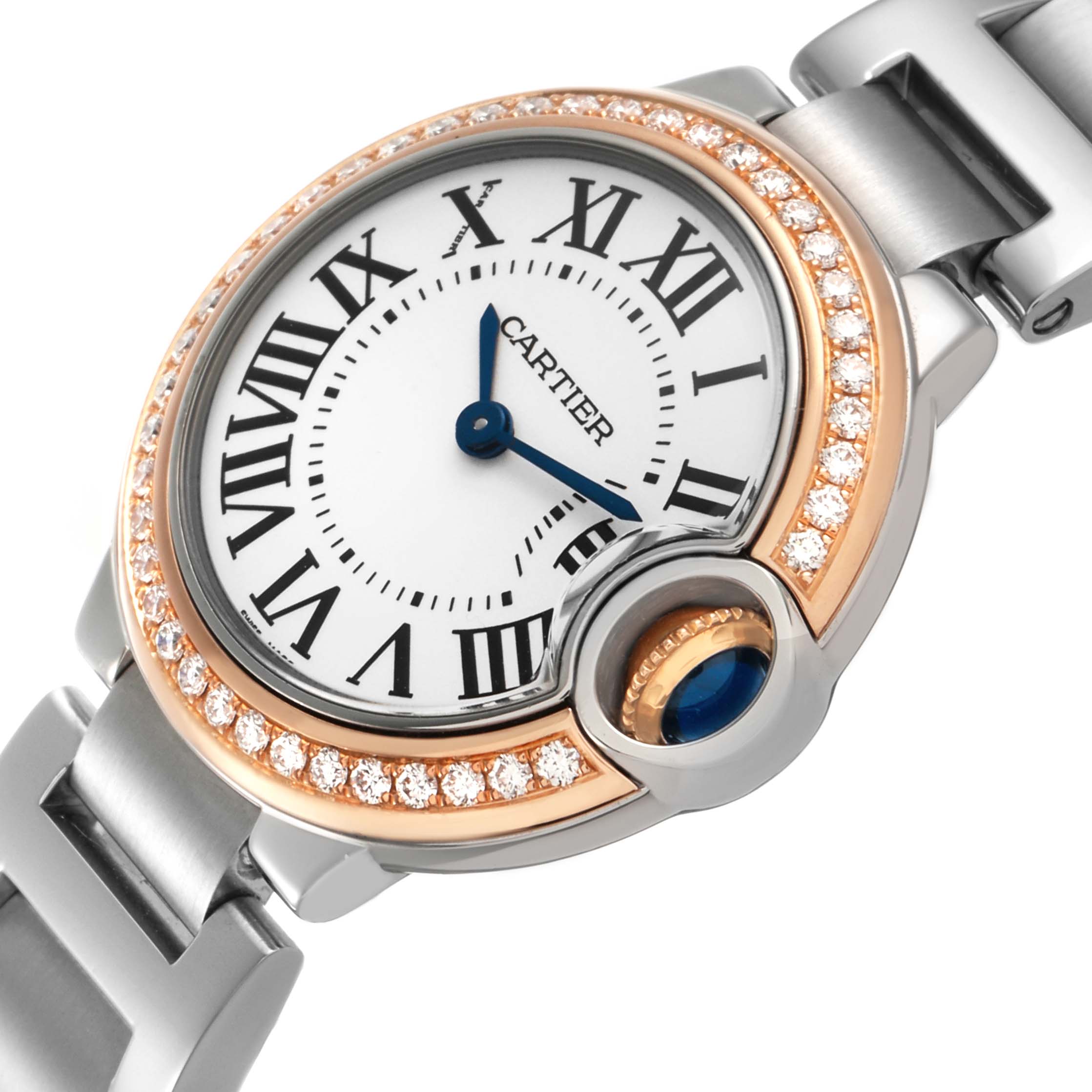 The Cartier Ballon Bleu WE902079 Women's Steel and Gold (two tone) Silver Dial watch is shown at an angled top view, highlighting the dial, Roman numerals, diamond bezel, and part of the bracelet.