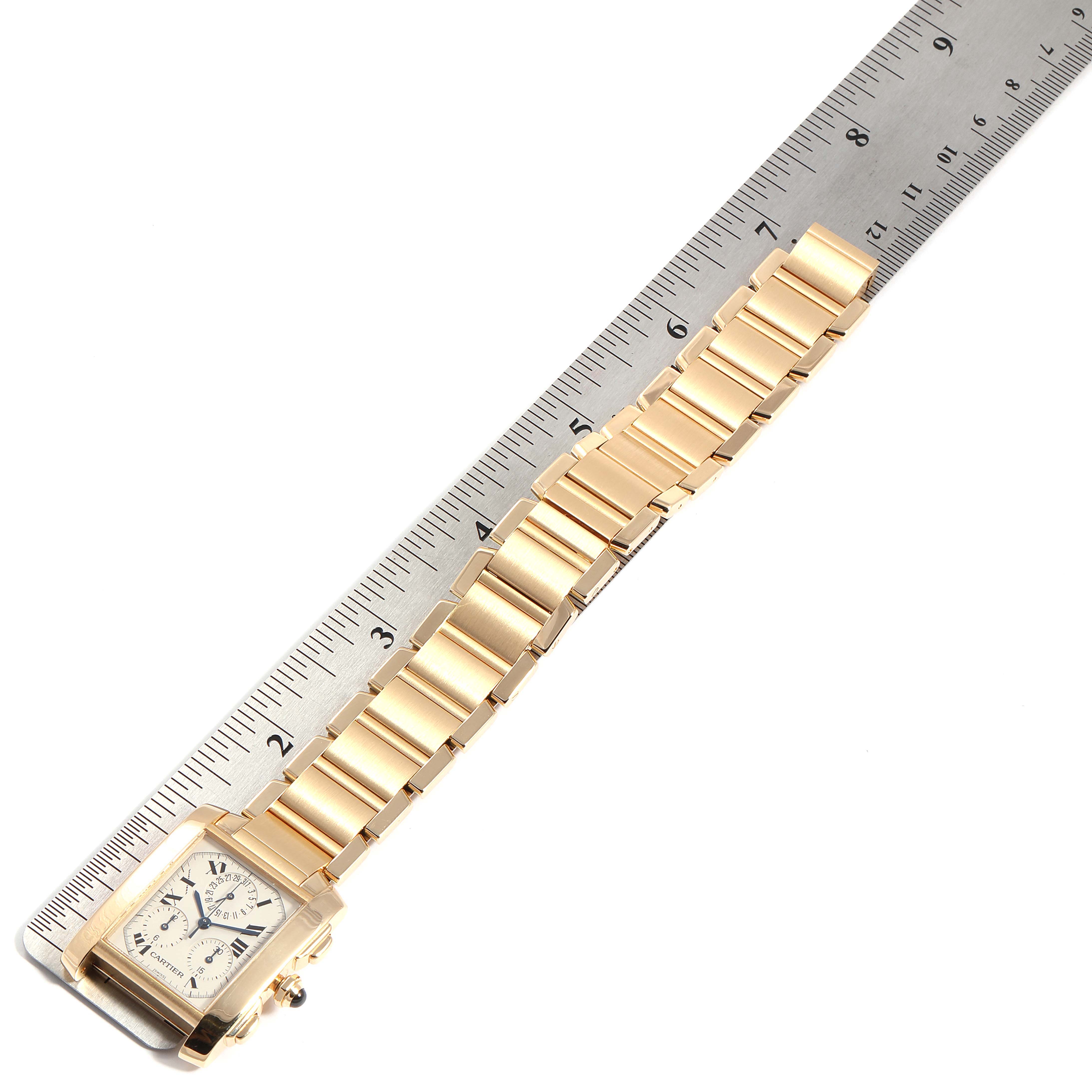 The image shows a Cartier Tank Française watch positioned diagonally with a ruler, displaying the case and most of the bracelet.