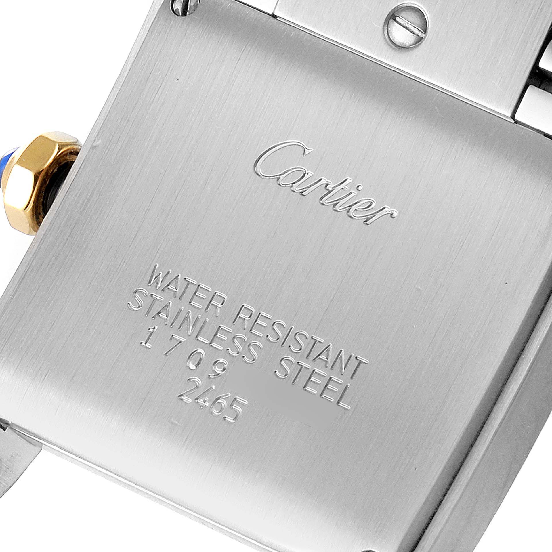 The image shows the back of a Cartier Tank Francaise W51012Q4 Women's Steel and Gold (two tone) Silver Dial W51012Q4 Women's Steel and Gold (two tone) Silver Dial watch, highlighting inscriptions and a screw detail.