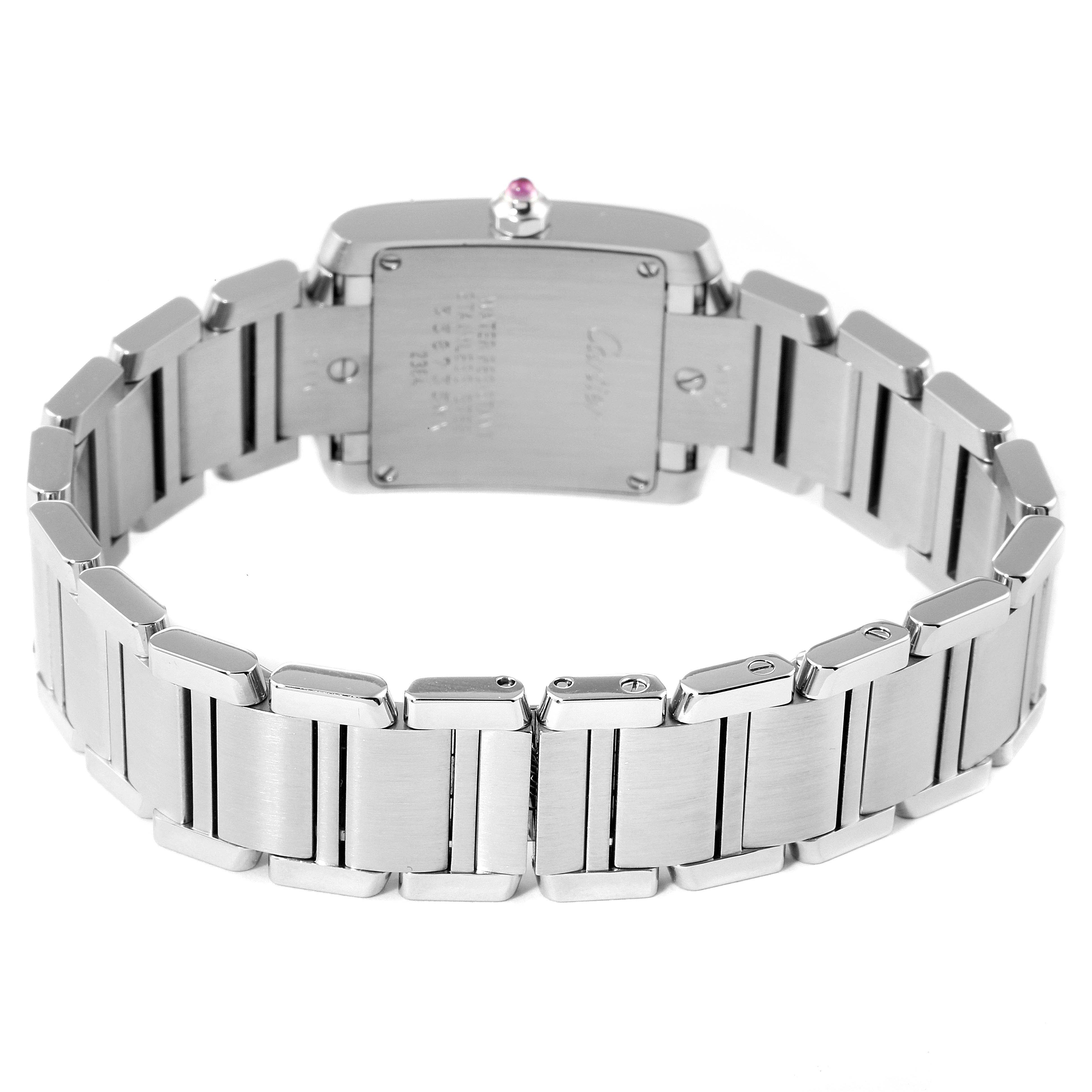 The image shows the back view of a Cartier Tank Française watch, highlighting its stainless steel bracelet and case back.