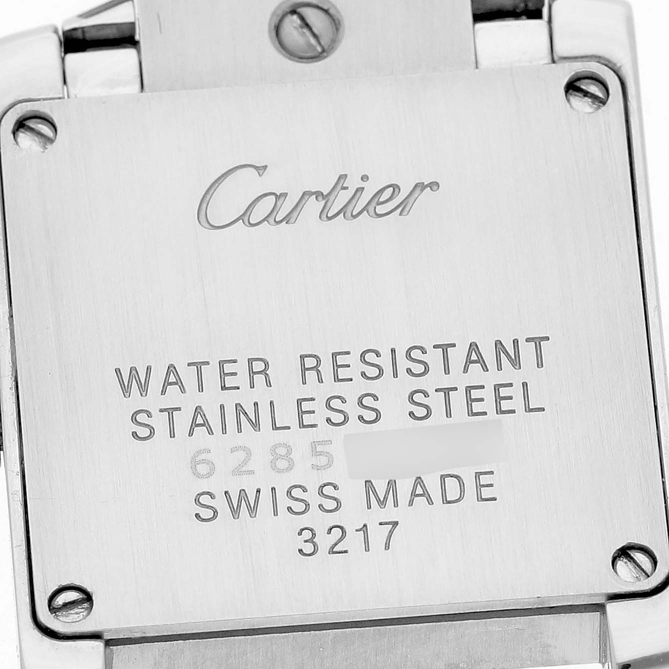 The image shows the back case of the Cartier Tank Française watch, highlighting its stainless steel build and markings.