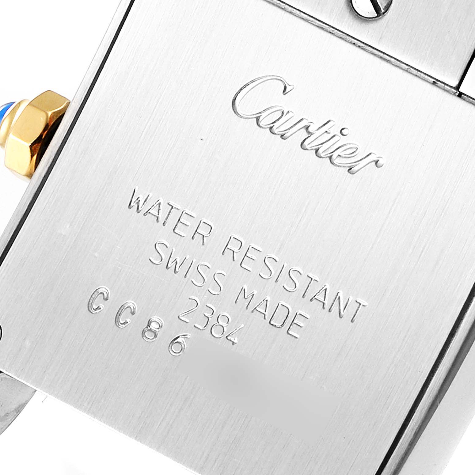 The image shows the back of a Cartier Tank Francaise W51007Q4 Women's Steel and Gold (two tone) Silver Dial W51007Q4 Women's Steel and Gold (two tone) Silver Dial watch with engraved specifications and part of the crown.