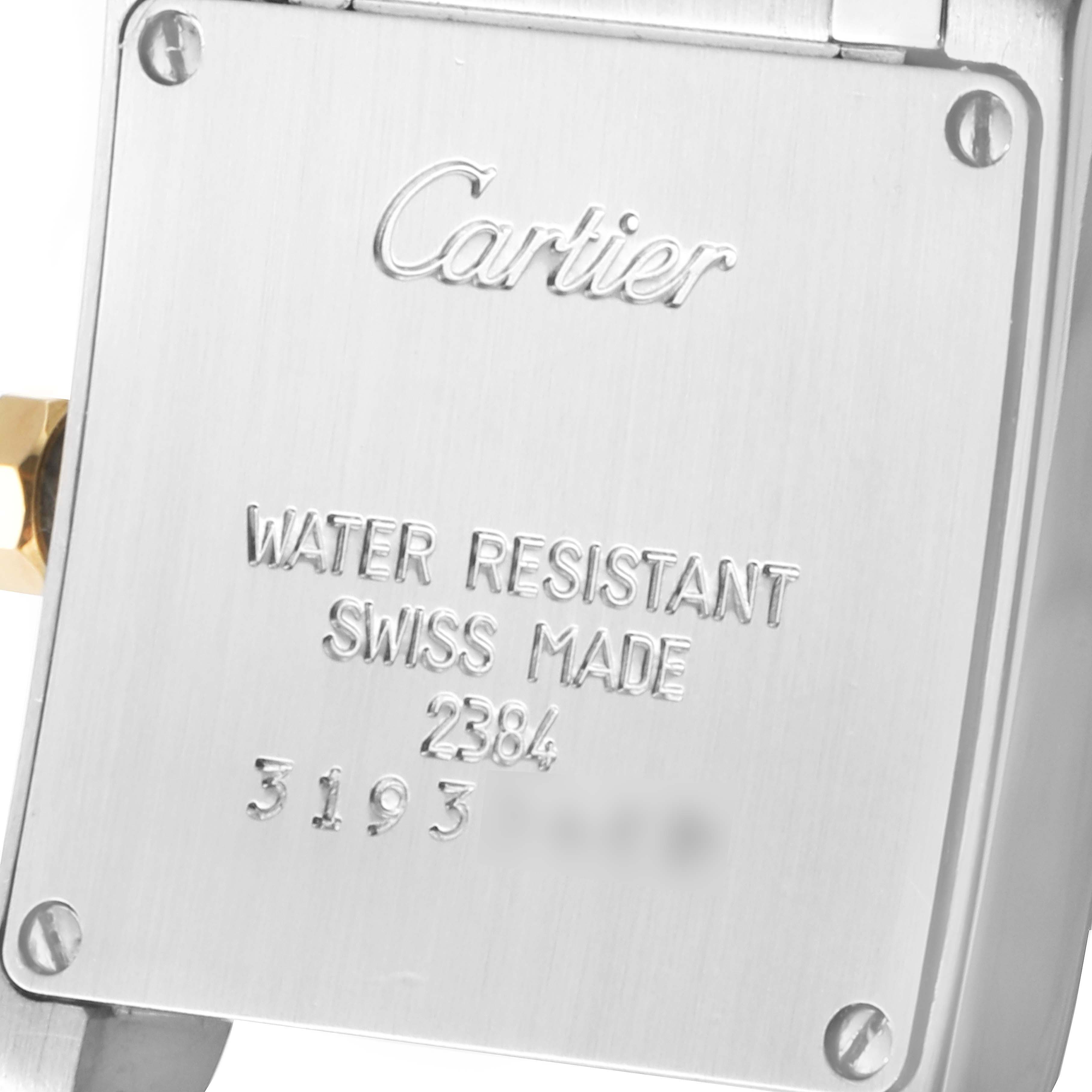 The image shows the back case of a Cartier Tank Francaise W51007Q4 Women
s Steel and Gold (two tone) Silver Dial W51007Q4 Women
s Steel and Gold (two tone) Silver Dial watch, displaying brand engravings and water-resistant information.