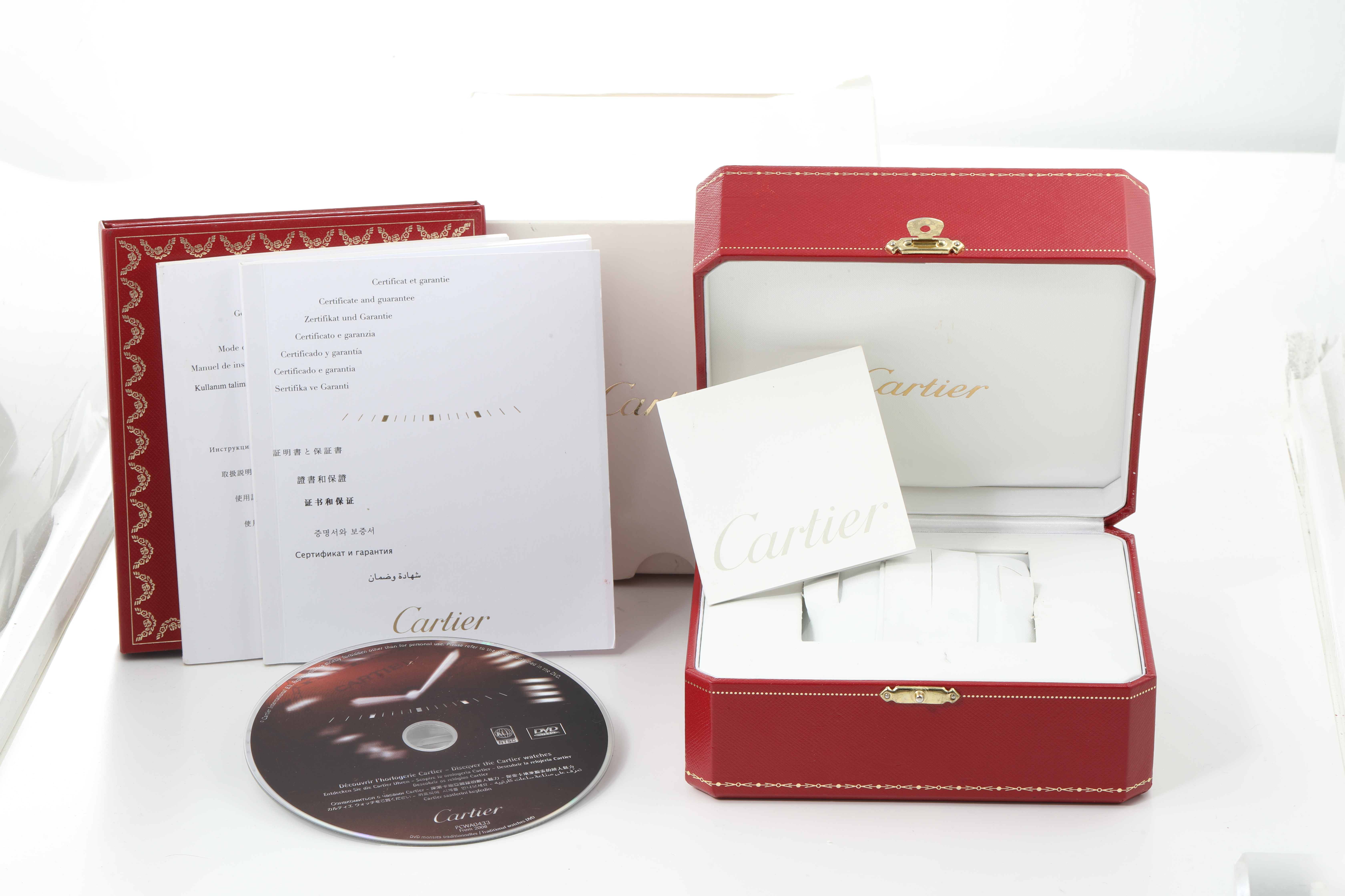 The image shows the packaging contents of a Cartier Tank Francaise W51007Q4 Women's Steel and Gold (two tone) Silver Dial W51007Q4 Women's Steel and Gold (two tone) Silver Dial, including the box, manuals, and a CD, arranged at a front angle.