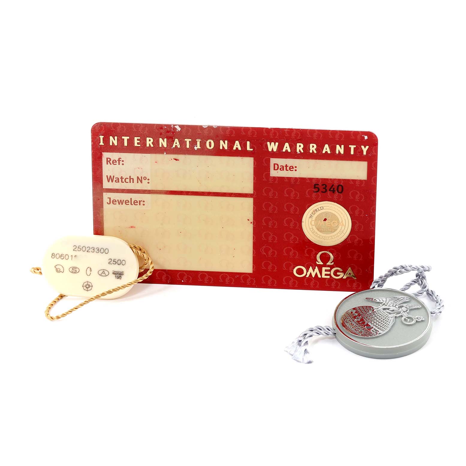 The image shows an Omega Aqua Terra 2502.33.00 Men
s Stainless Steel Silver Dial 2502.33.00 Men
s Stainless Steel Silver Dial model
s international warranty card, a tag, and a medallion.