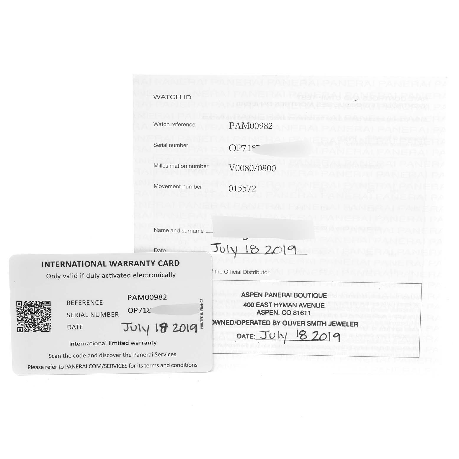 This image shows the international warranty card and paperwork for a Panerai Submersible PAM00982 Men's Titanium Grey Dial PAM00982 Men's Titanium Grey Dial model watch, displayed from a top-down angle.