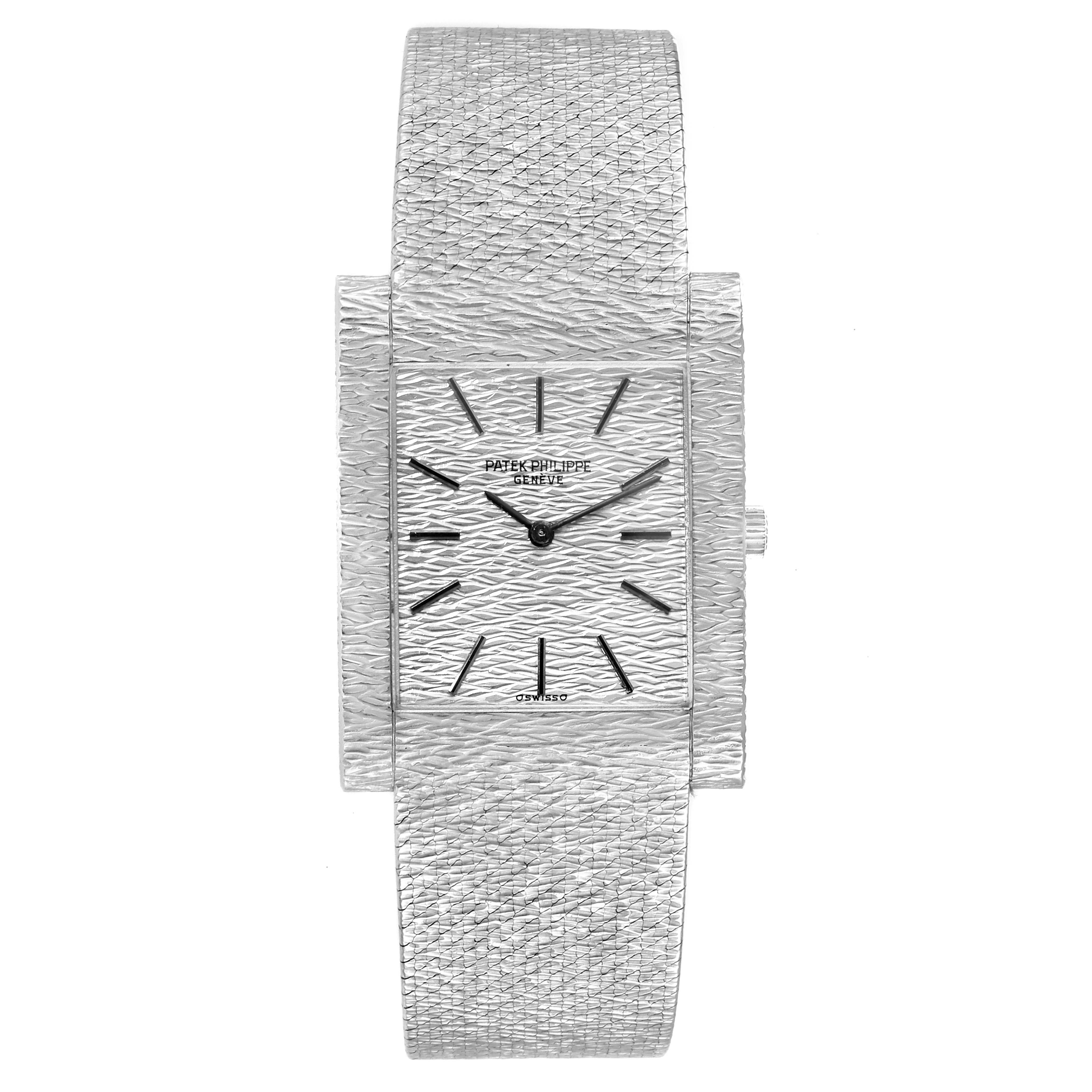 The image shows a front view of a Vintage Patek Philippe watch, highlighting its textured bracelet and rectangular dial.
