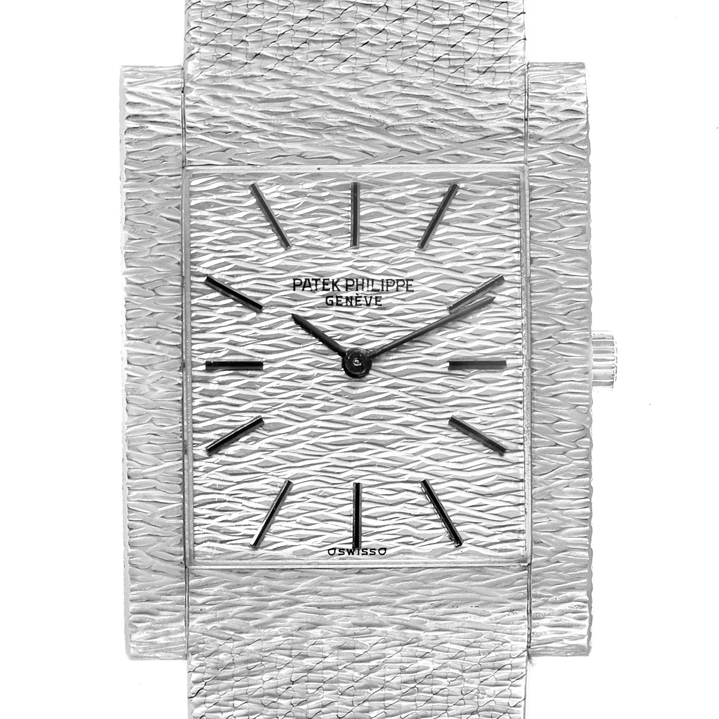 This image shows a close-up, front view of a Vintage Patek Philippe watch, highlighting its textured dial and rectangular case.