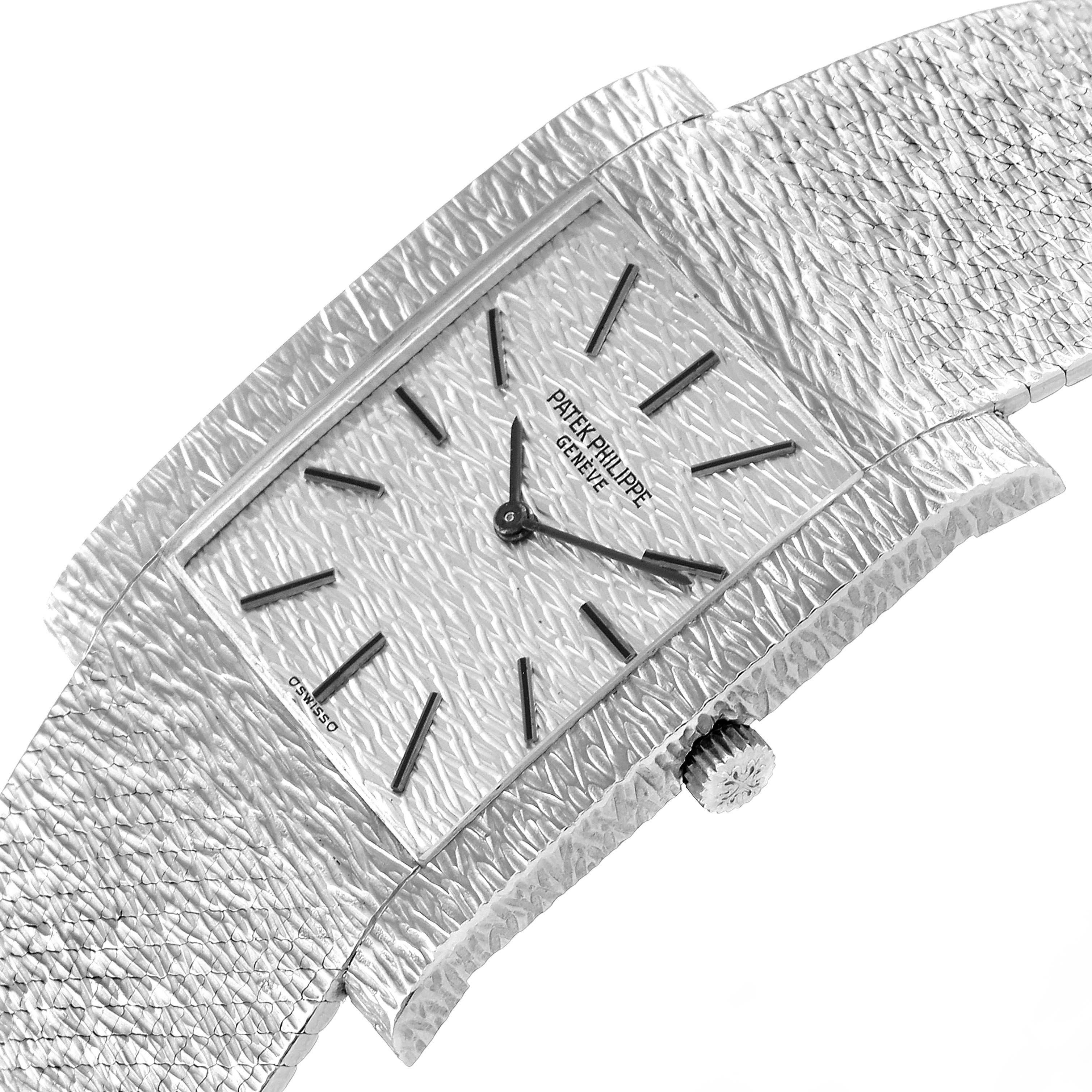 The image shows a close-up, angled view of a Vintage Patek Philippe watch, highlighting its textured dial, case, and crown.