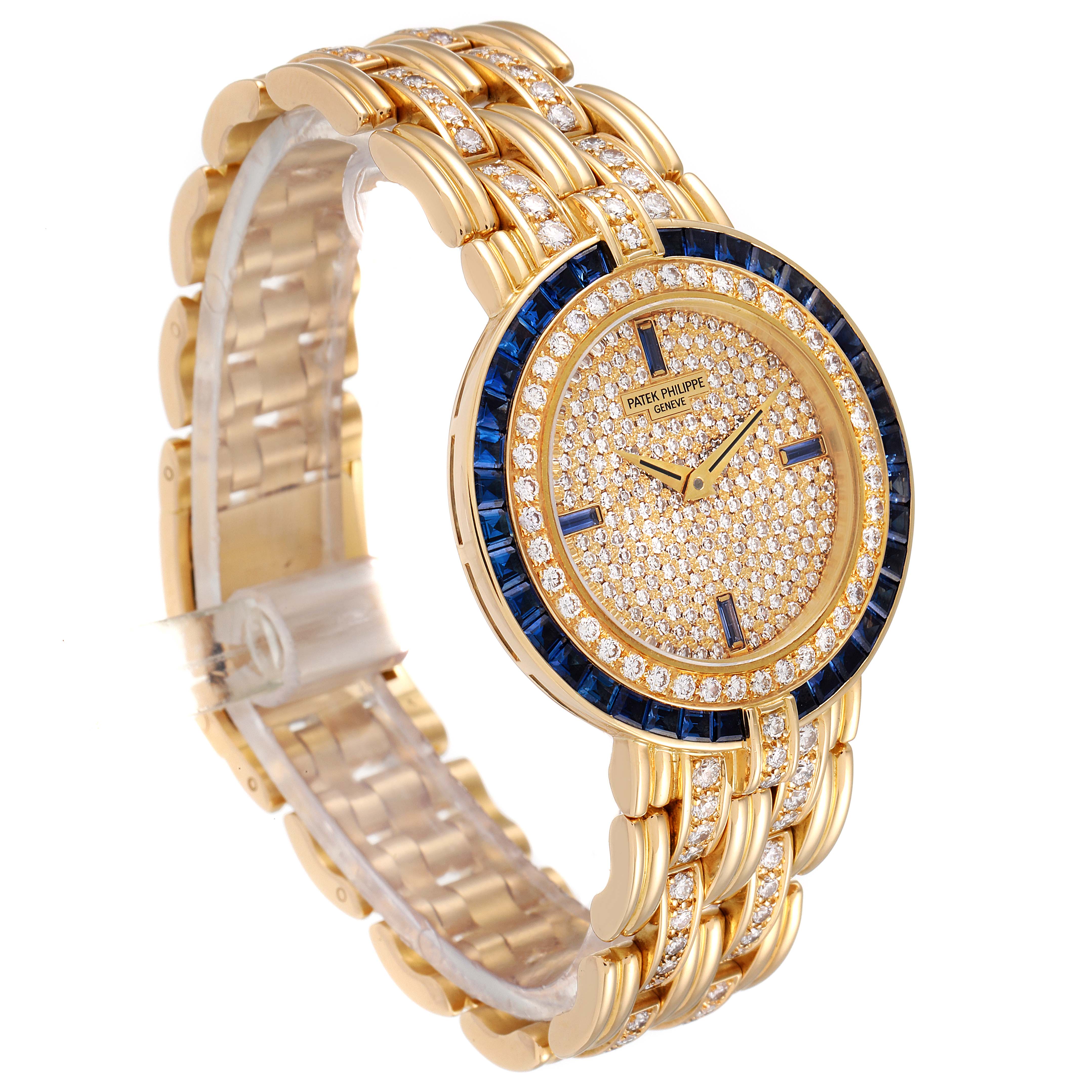 This image shows a Patek Philippe 3982/11 Women's Yellow Gold  3982/11 Women's Yellow Gold  3982 Ladies Watch in 18k yellow gold adorned with diamonds and sapphires, viewed from an angled perspective highlighting the face and band.