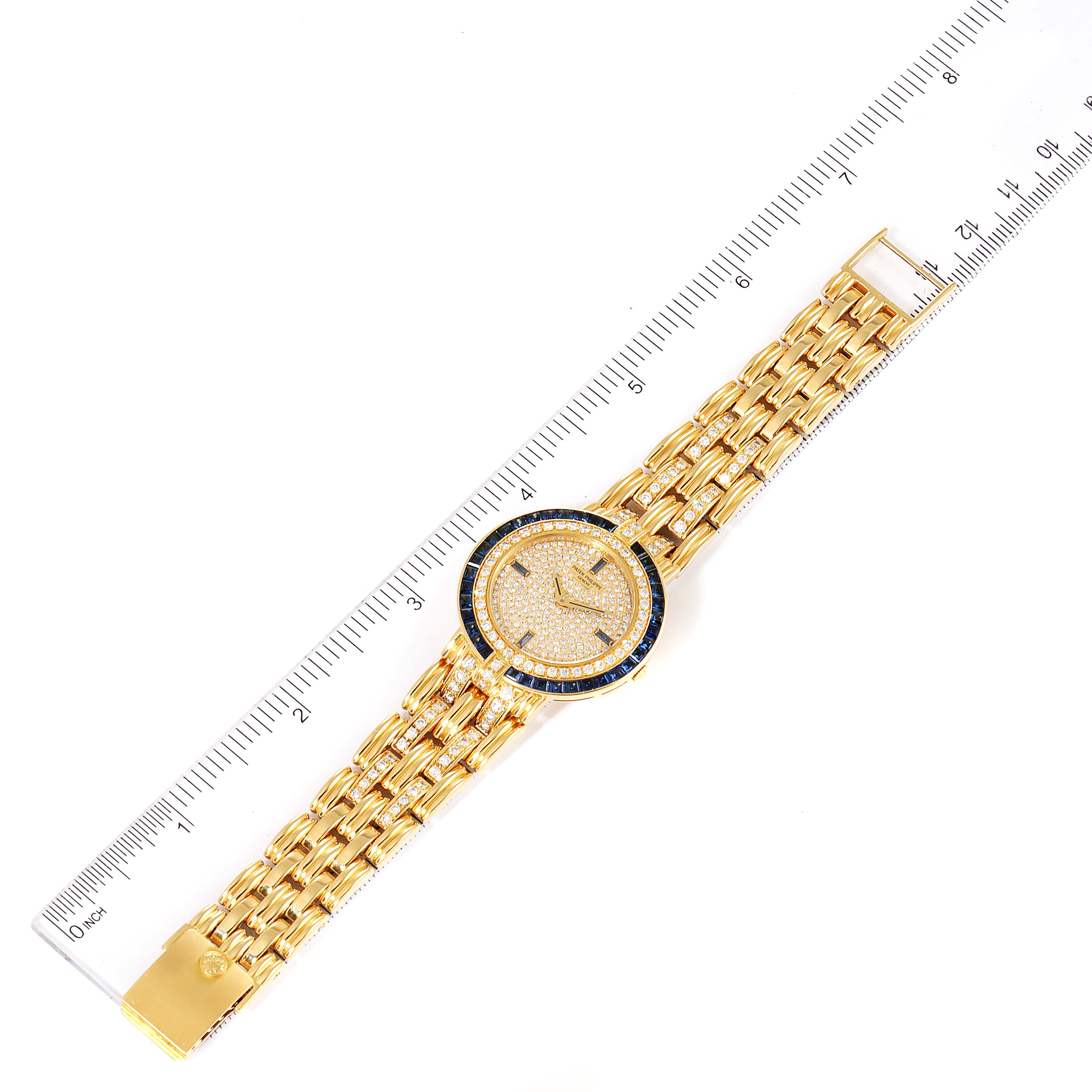 The Patek Philippe 3982/11 Women's Yellow Gold  3982/11 Women's Yellow Gold  3982 Ladies Watch is shown from a top view, highlighting its 18k yellow gold case, diamond dial, and sapphire accents.