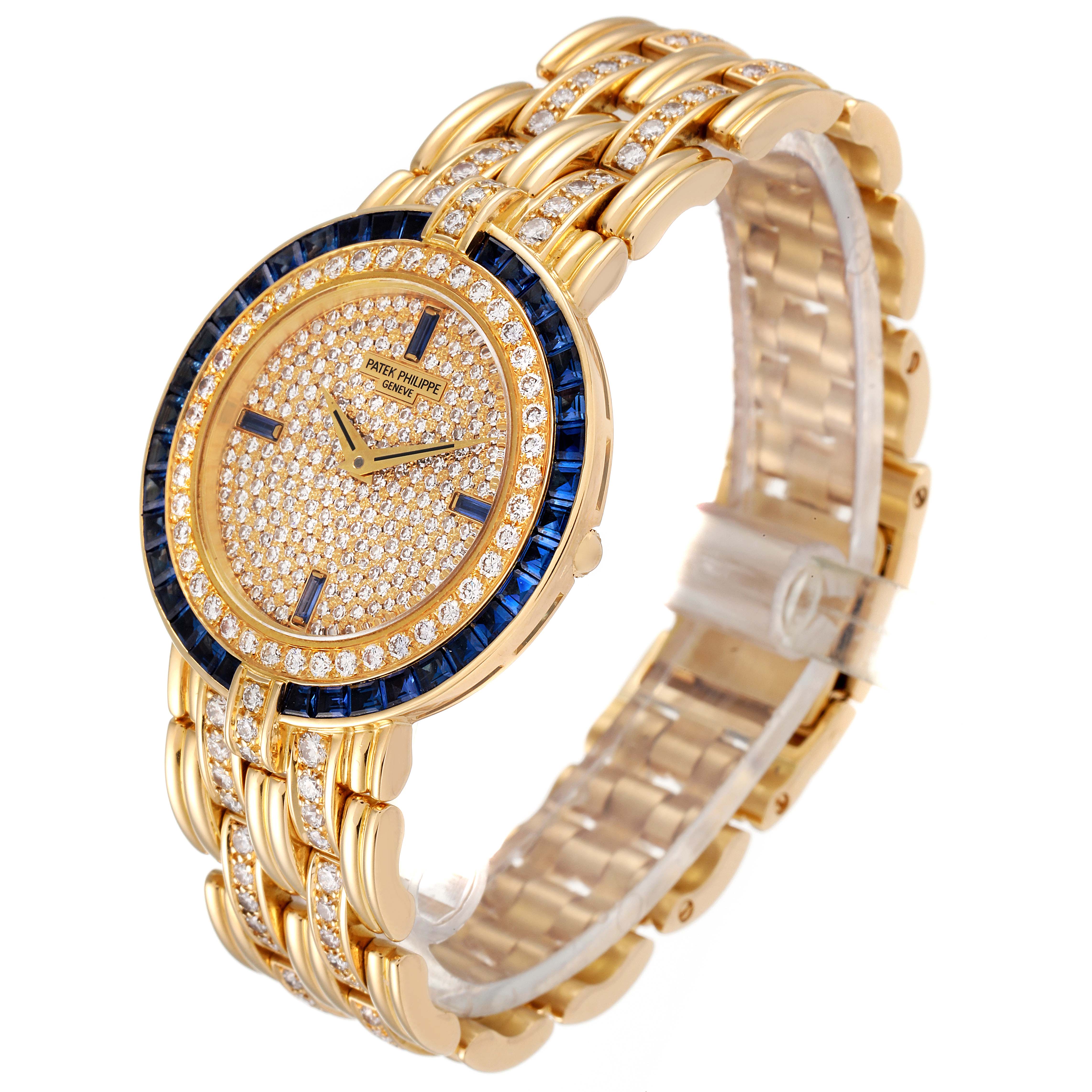This image shows a side view of the Patek Philippe 3982/11 Women's Yellow Gold  3982/11 Women's Yellow Gold  3982 Ladies Watch, featuring an 18k yellow gold case adorned with diamonds and sapphires.