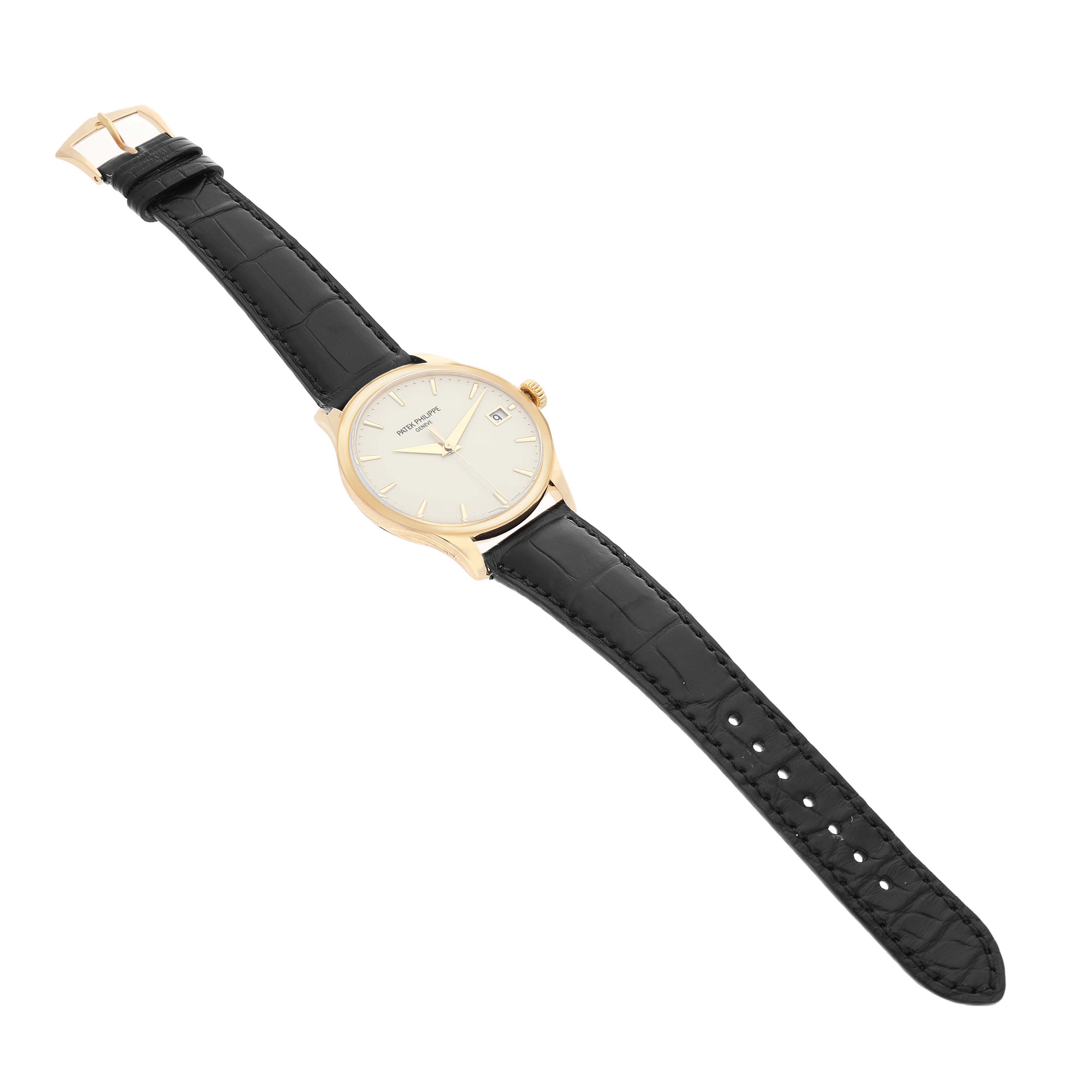 The Patek Philippe Calatrava 5227J Men's Yellow Gold White Dial watch is shown at an angle displaying the face, crown, and full leather strap.