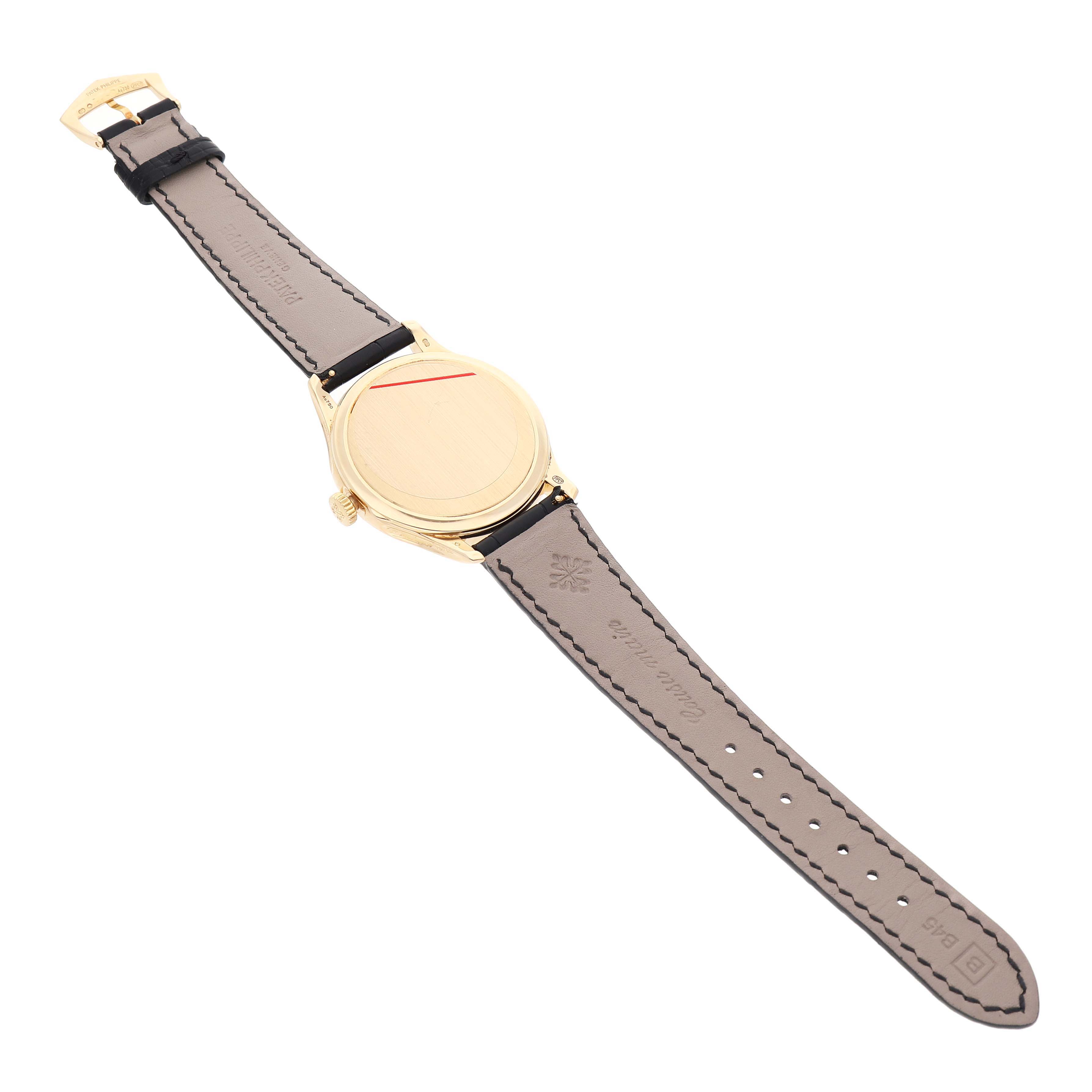The image shows the back view of a Patek Philippe Calatrava 5227J Men's Yellow Gold White Dial watch, featuring the case back and leather strap.