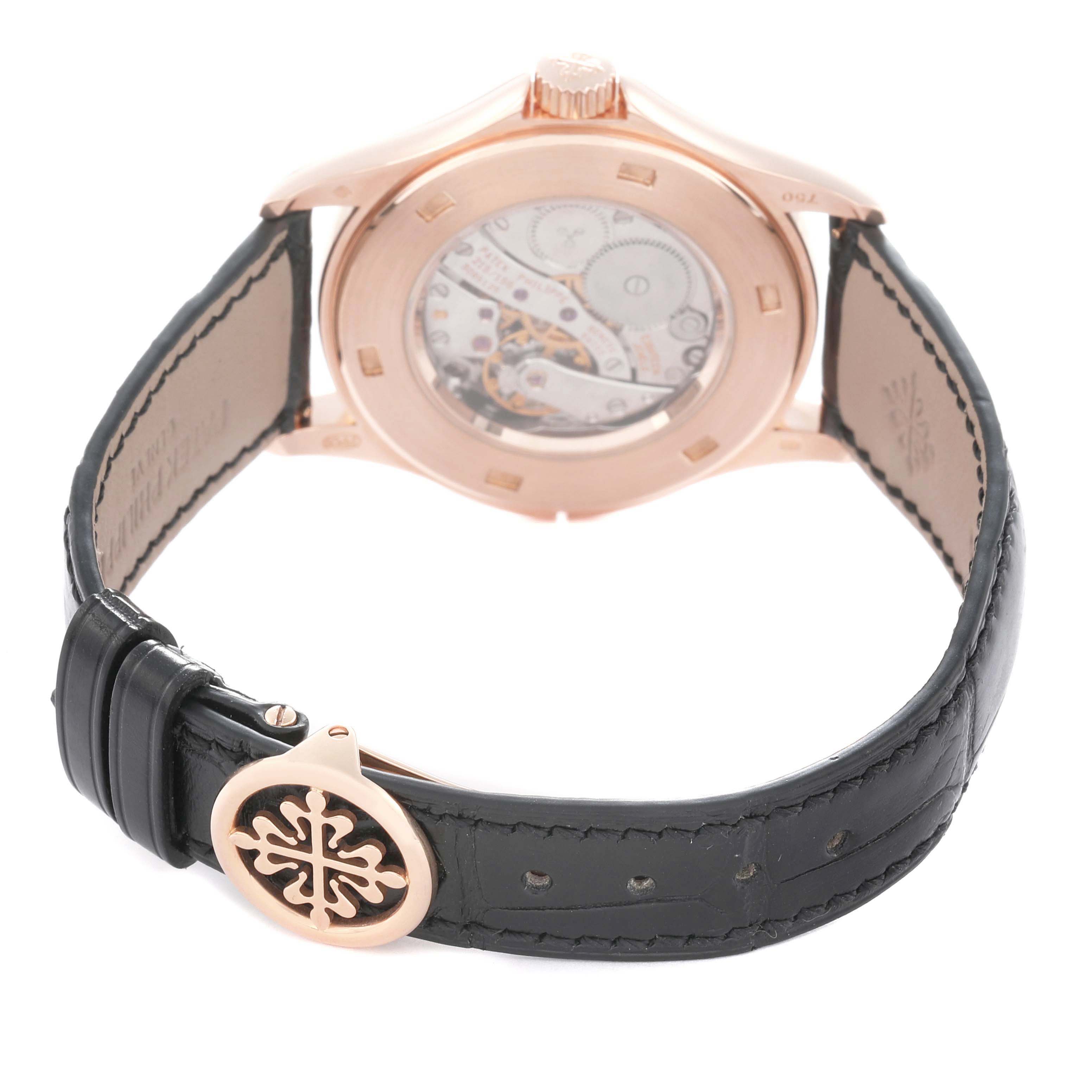 The image shows the back case view of the Patek Philippe Calatrava 5134R Men
s Rose Gold White Dial, highlighting the movement and leather strap with a branded clasp.