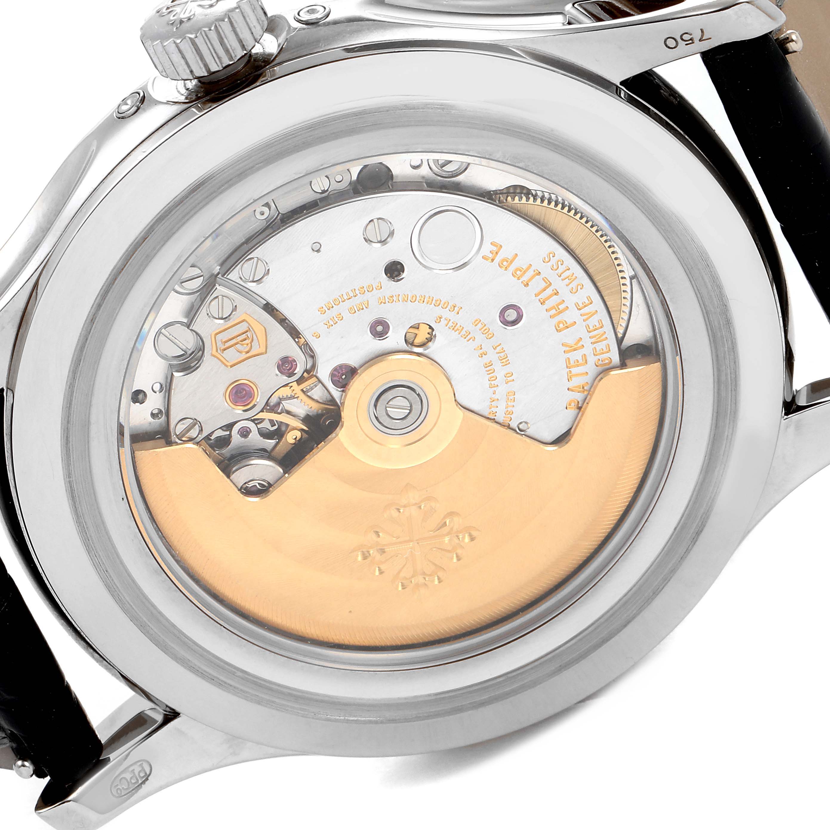 The image shows the back view of a Patek Philippe Complications 5205G - 010 Men's White Gold Grey Dial 5205G - 010 Men's White Gold Grey Dial watch, highlighting its intricate mechanical movement.