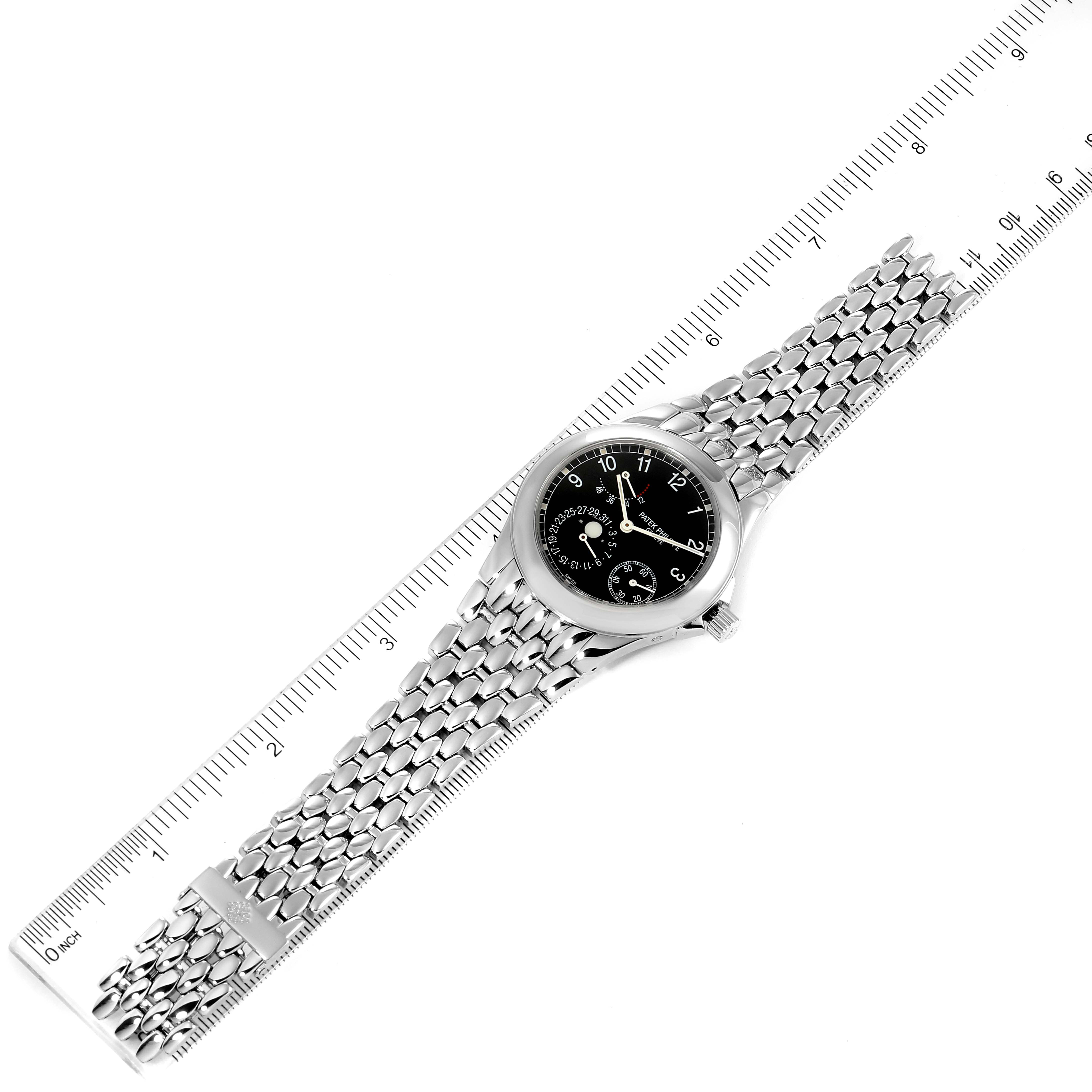 The image shows a Patek Philippe Neptune 5085A/1A-001 Men's Stainless Steel Black Dial 5085A/1A-001 Men's Stainless Steel Black Dial model watch laid flat with a ruler alongside it for measurement.