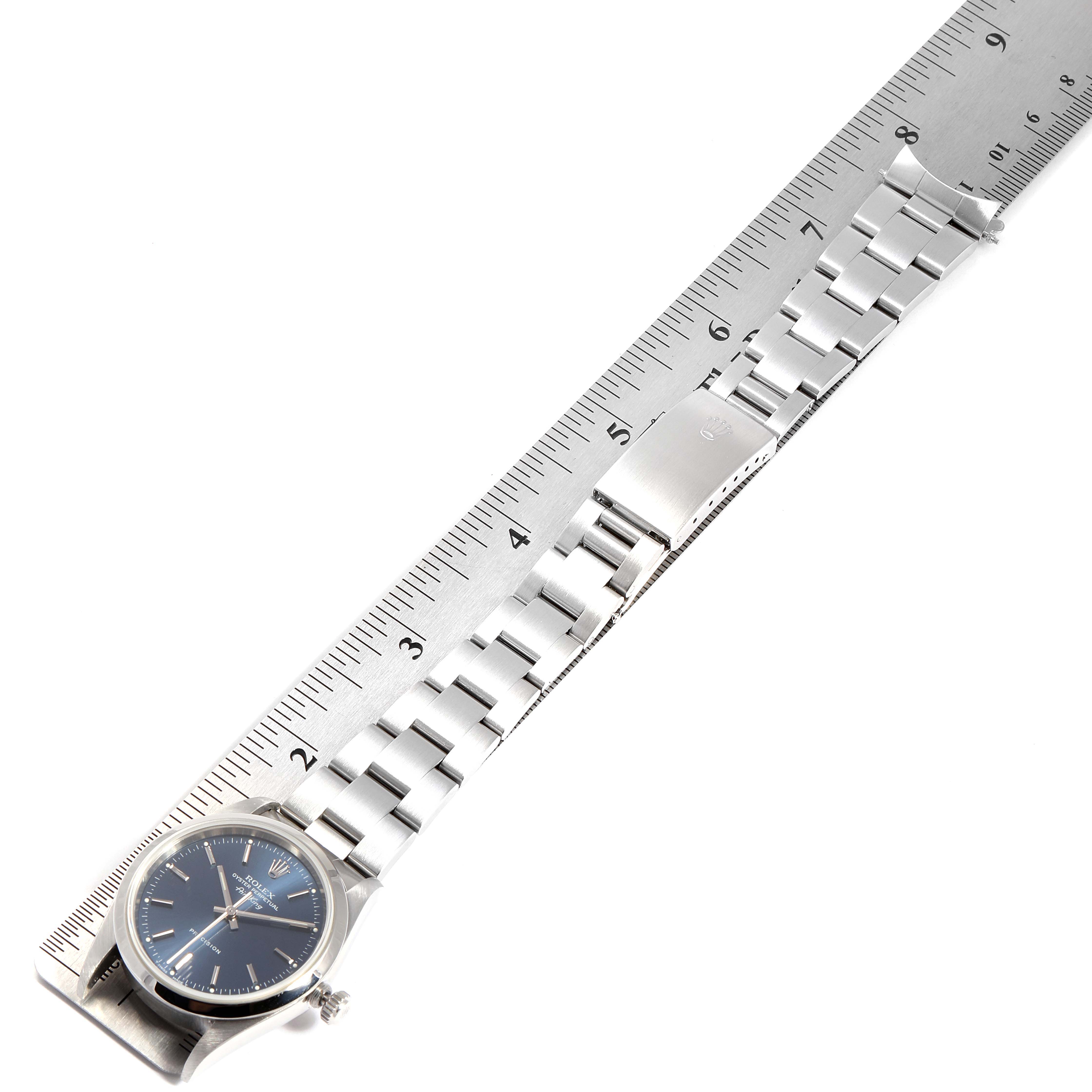 The image shows a side view of a Rolex Air-King 14000M Men's Stainless Steel Blue Dial 14000M Men's Stainless Steel Blue Dial model watch with its bracelet laid next to a ruler.