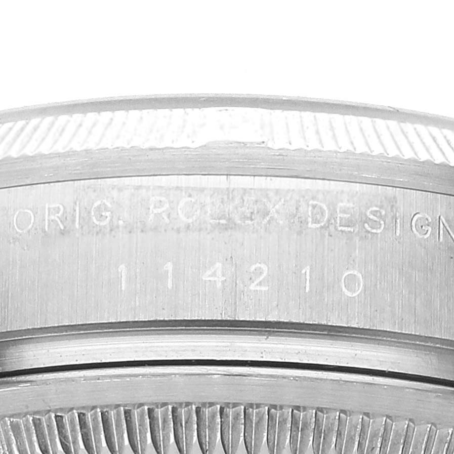 This image shows a close-up of the side of a Rolex Air-King 114210 Men's Stainless Steel White Dial 114210 Men's Stainless Steel White Dial model, highlighting its engraved serial number.