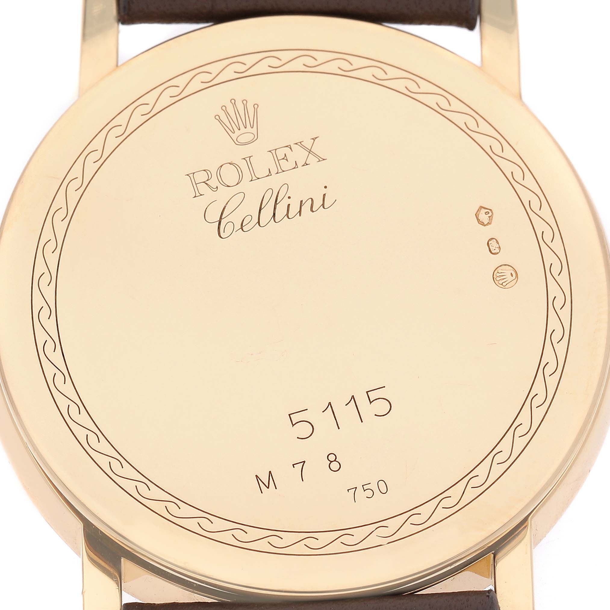 The image shows the back case of a Rolex Cellini 5115/8 Men's Yellow Gold White Dial watch, displaying engravings and hallmarks.