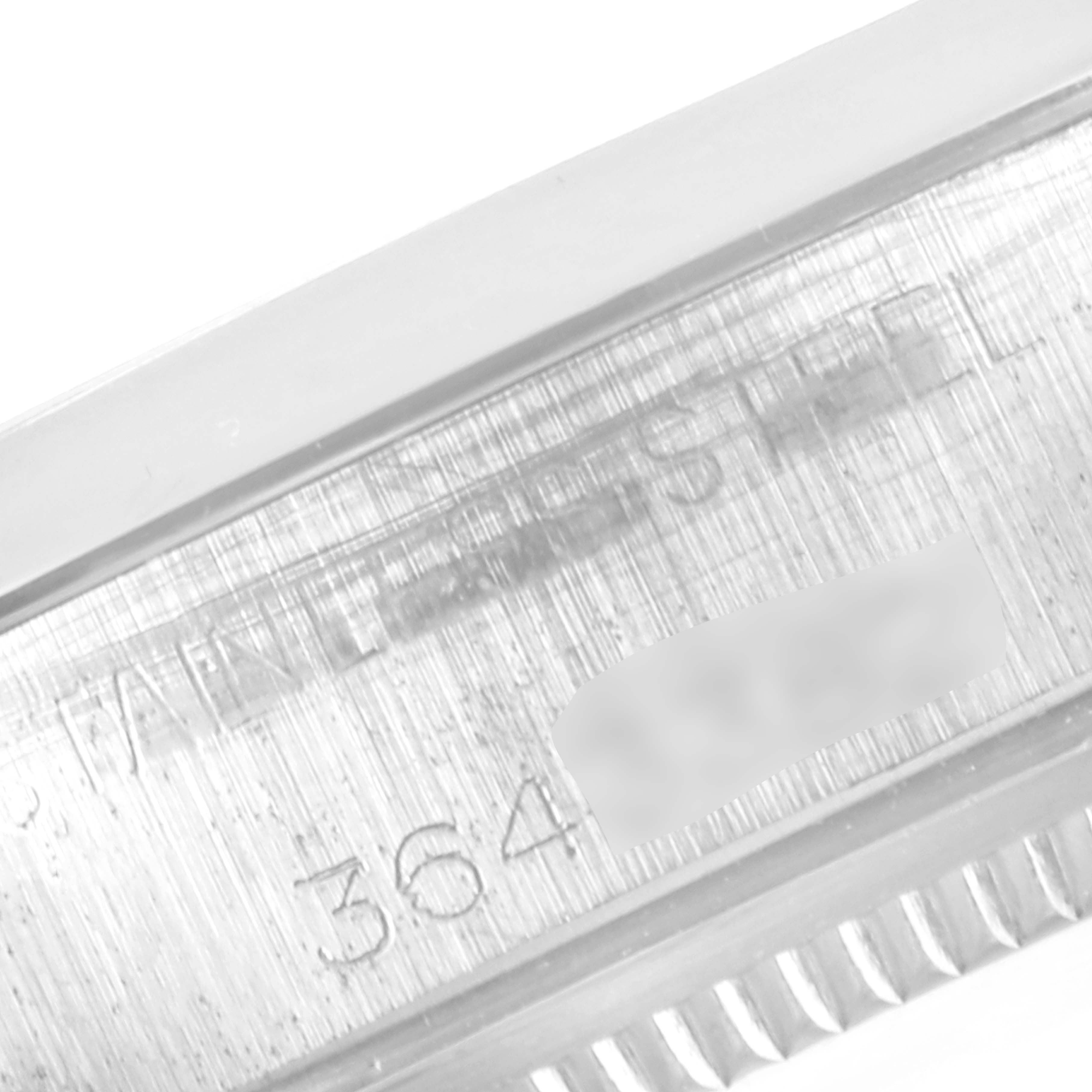 The image shows a close-up of the engraved stainless steel case back of a Vintage Collection Rolex watch.