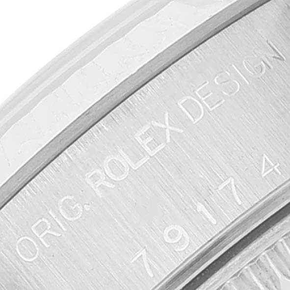 The image shows a close-up of the case back of the Rolex Datejust 79174 Women
s Stainless Steel Pink Dial 79174 Women
s Stainless Steel Pink Dial watch, displaying the engraved text.