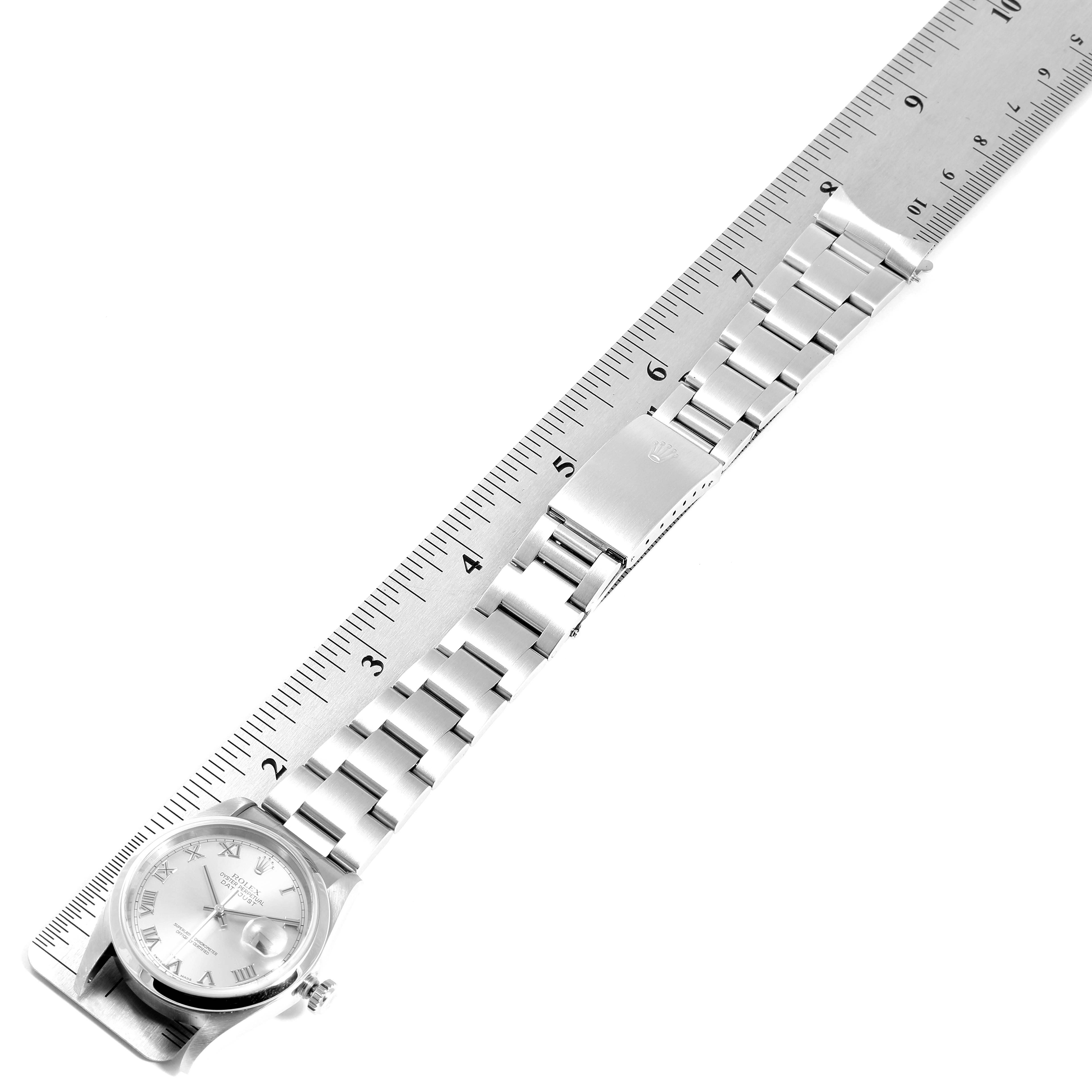 The Rolex Datejust 16200 Men
s Stainless Steel Grey Dial 16200 Men
s Stainless Steel Grey Dial watch is shown laid flat with its metal bracelet extended and a ruler placed next to it for scale.