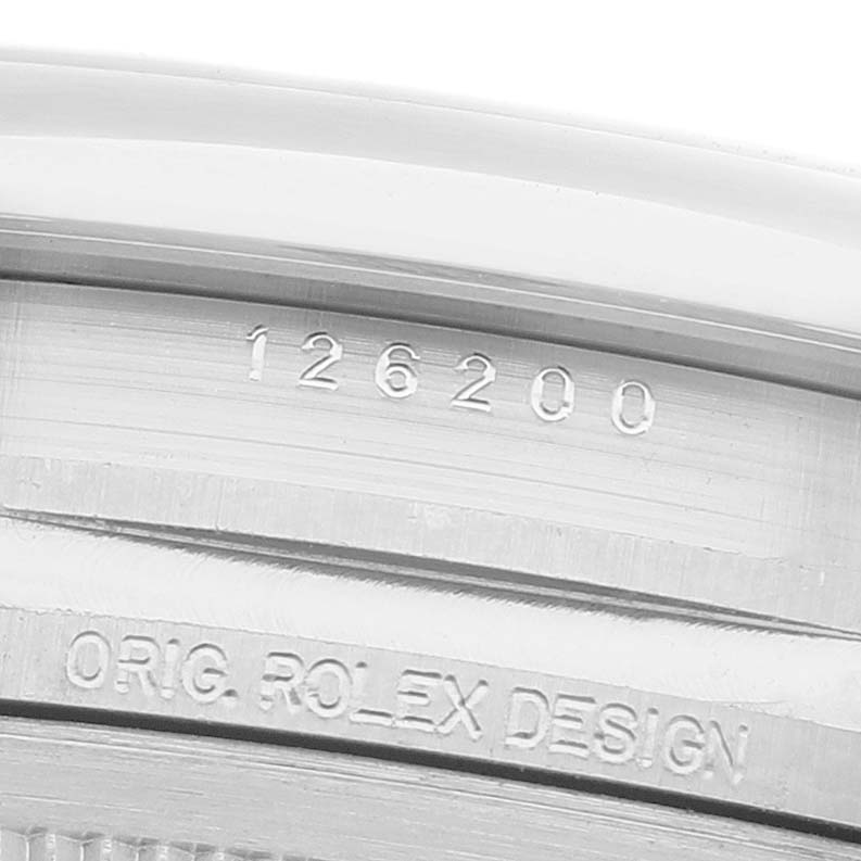 The image shows a close-up of the Rolex Datejust 126200 Men's Stainless Steel Green Dial model's watch case engraving, highlighting the model number and branding.