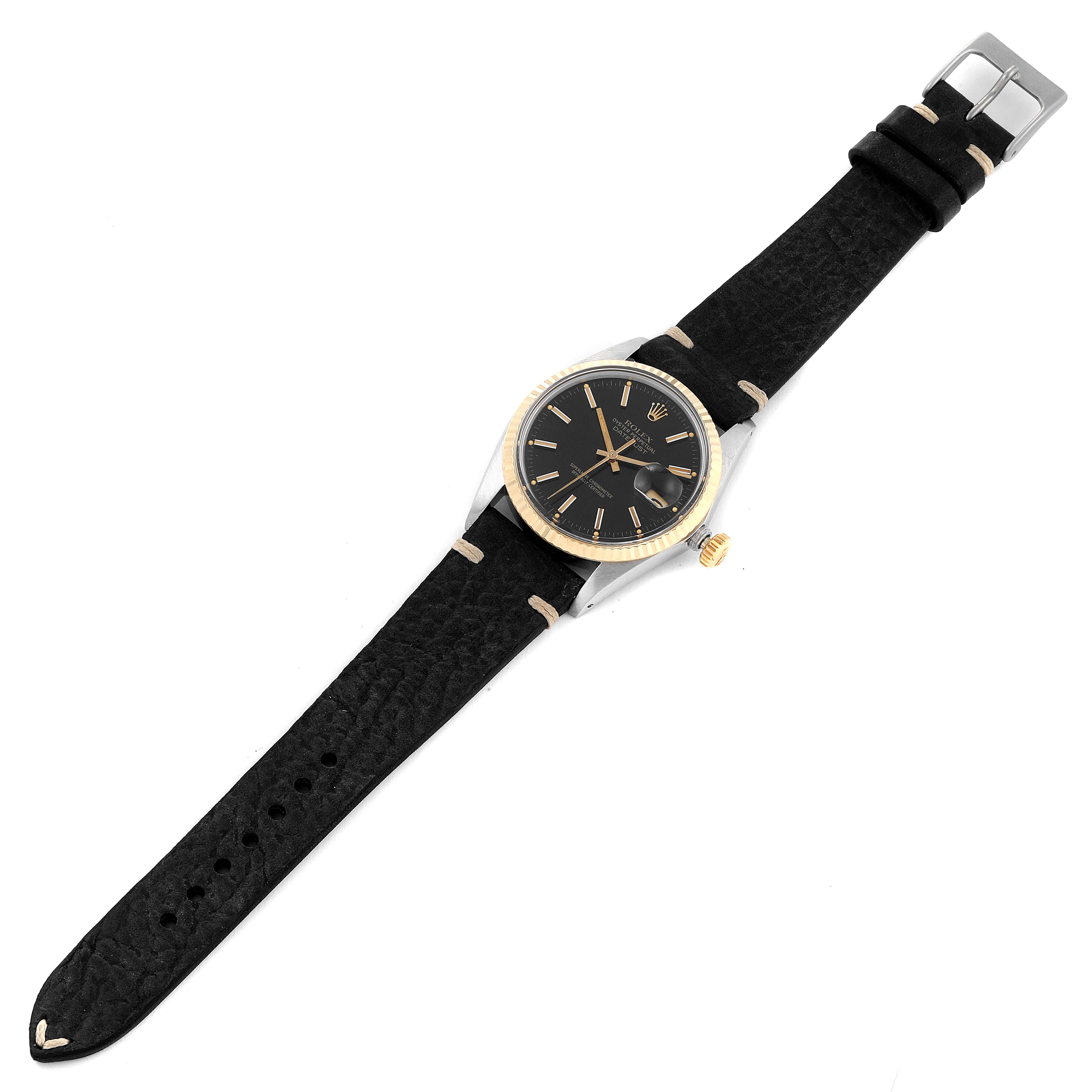 The image shows a Rolex Vintage Collection 16013 Men's Steel and Gold (two tone) Black Dial 16013 Men's Steel and Gold (two tone) Black Dial watch from a top-down angle, highlighting its leather strap and classic face.