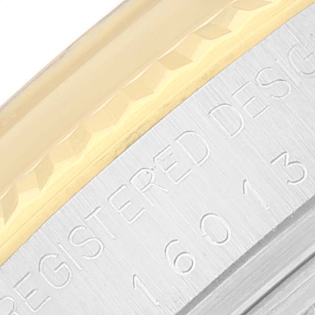 This close-up image shows the engraved case side and the gold bezel of the Rolex Vintage Collection 16013 Men's Steel and Gold (two tone) Black Dial 16013 Men's Steel and Gold (two tone) Black Dial watch, model 16013.