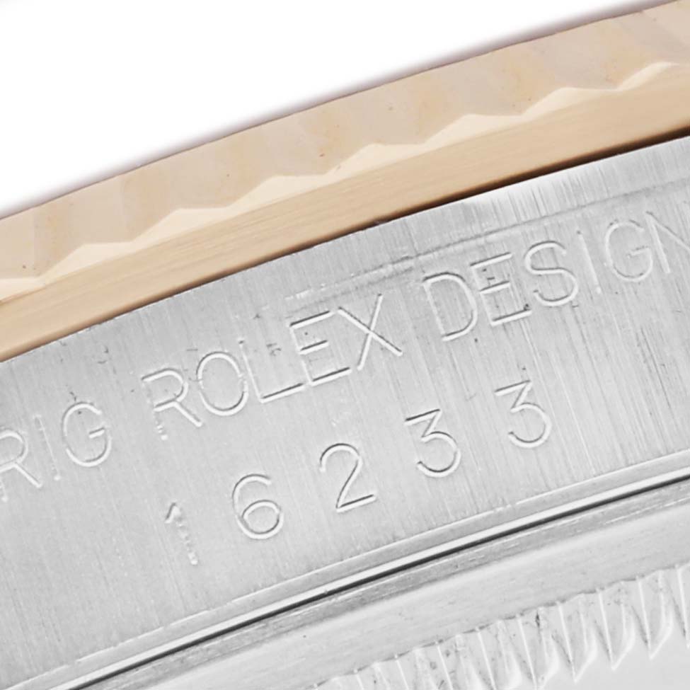 The image shows a close-up of the engraved bezel and edge of a Rolex Datejust 16233 Men
s Steel and Gold (two tone) Champagne Dial watch, highlighting the model number.