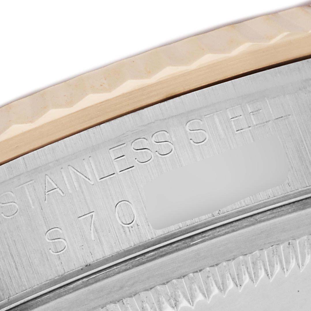 The image shows a close-up of the case back edge and bezel of a Rolex Datejust 16233 Men
s Steel and Gold (two tone) Champagne Dial, highlighting the "STAINLESS STEEL" engraving.