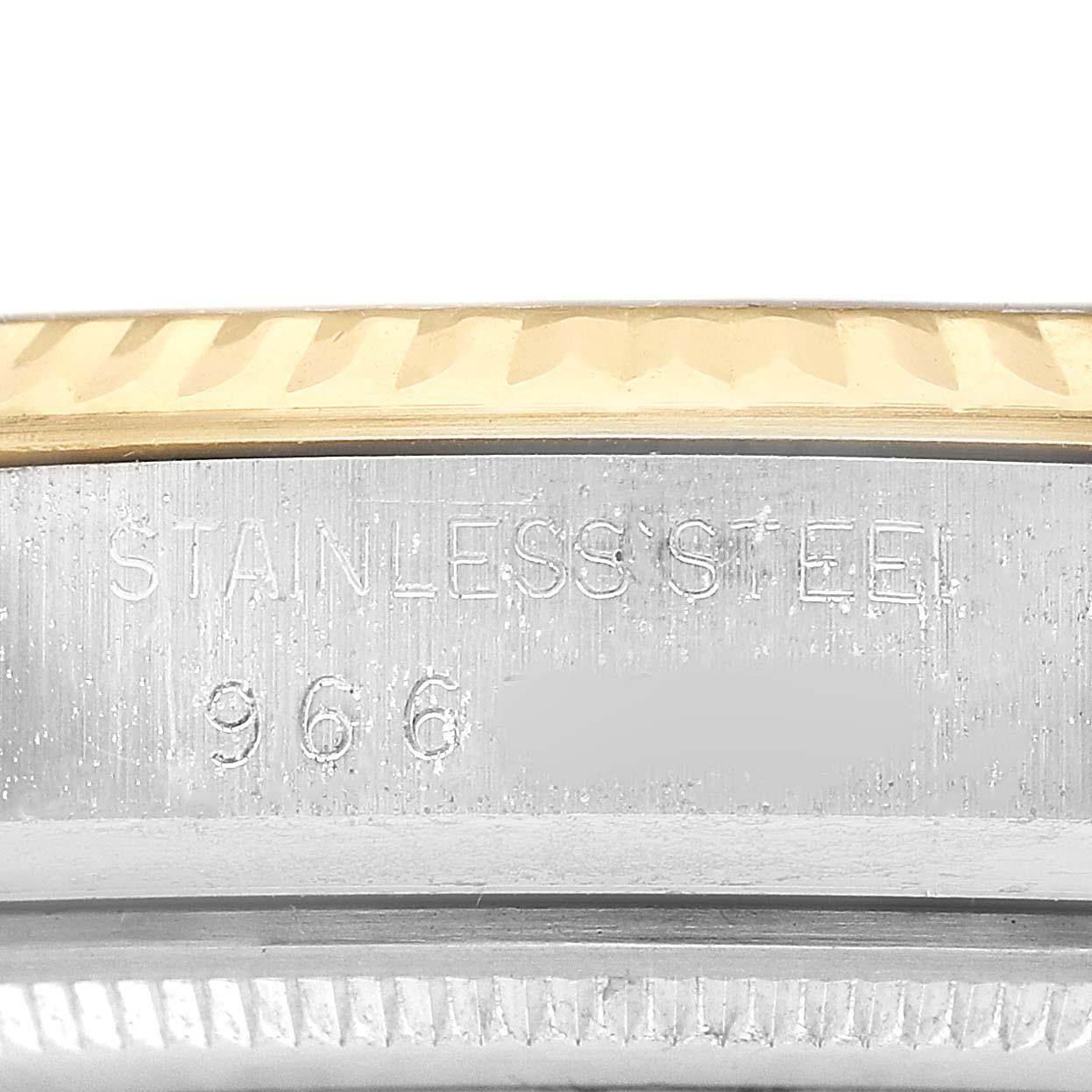 The image shows a close-up of the edge of a Rolex Datejust 16013 Men's Steel and Gold (two tone) Champagne Dial with stainless steel and gold bezel elements.
