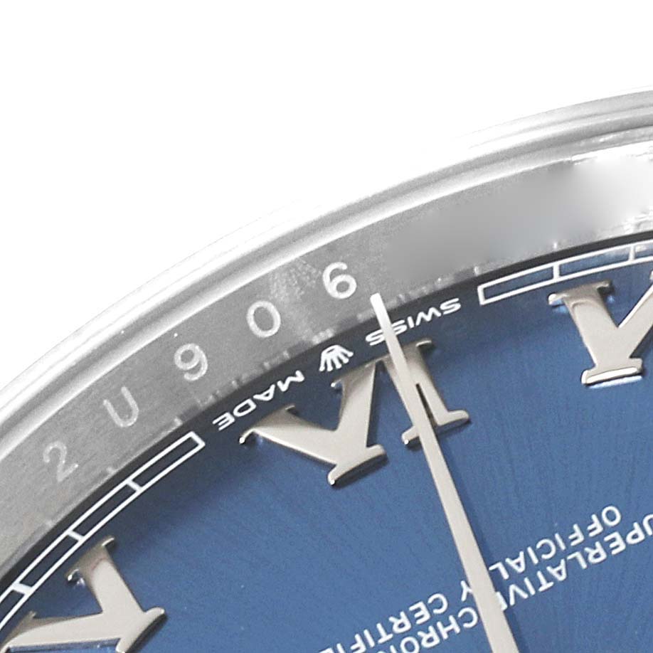 This image shows a close-up of the dial and part of the bezel of the Rolex Datejust 41 126300 Men's Stainless Steel Blue Dial 126300 Men's Stainless Steel Blue Dial watch, highlighting the Roman numerals and inscriptions.