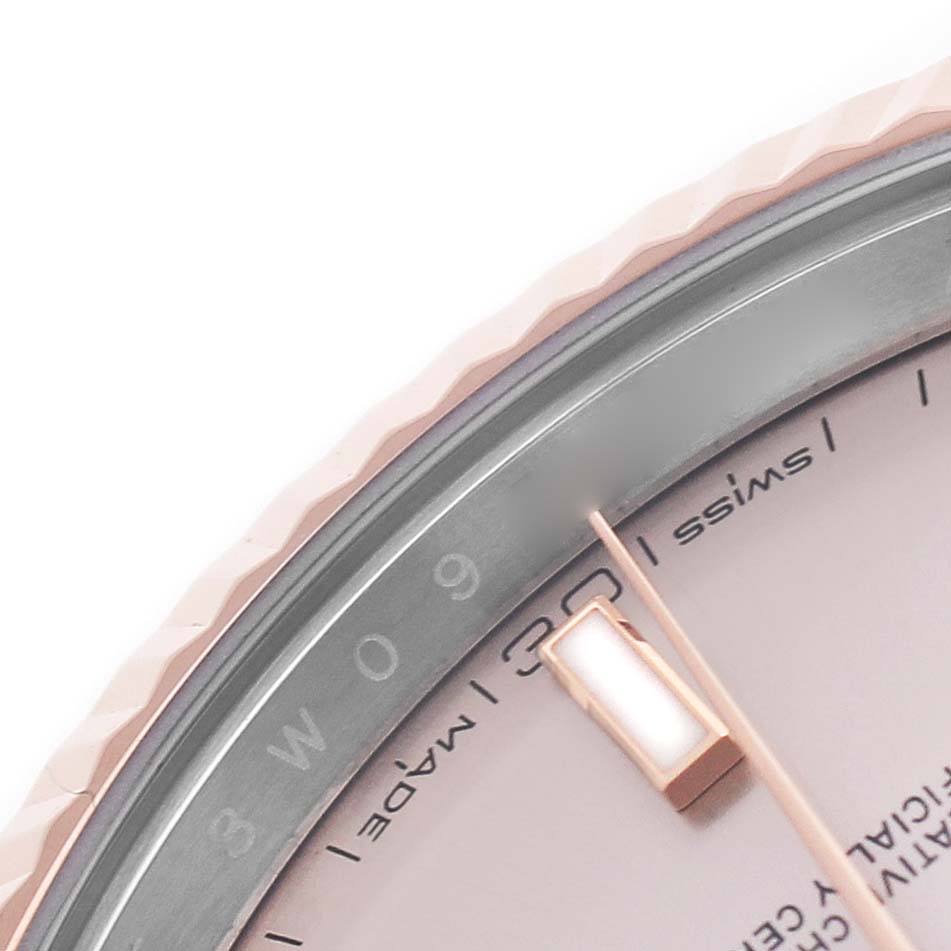 The image shows a close-up of the bezel, dial edge, and hand of a Rolex Datejust 126331 Men's Steel and Gold (two tone) Pink Dial watch.