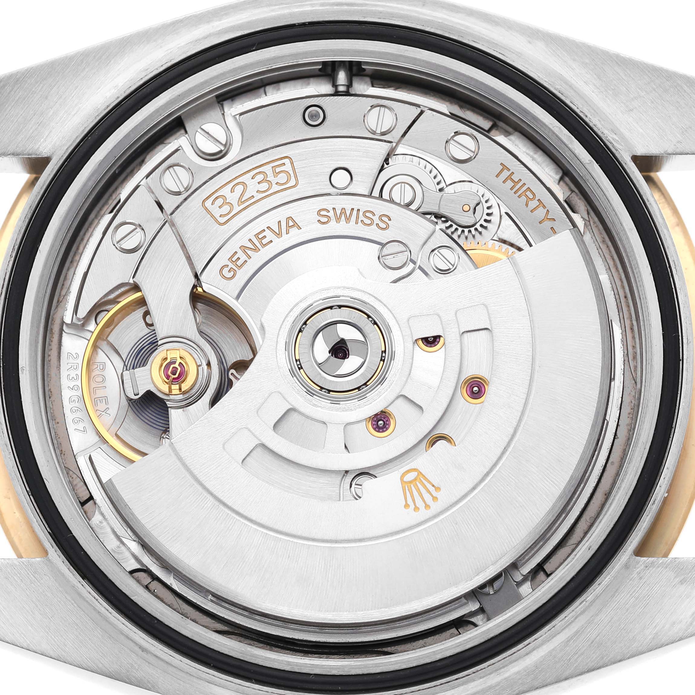 The image shows a close-up of the Rolex Datejust 41 126333 Men's Steel and Gold (two tone) Grey Dial's movement from the back, highlighting its rotor and intricate mechanics.