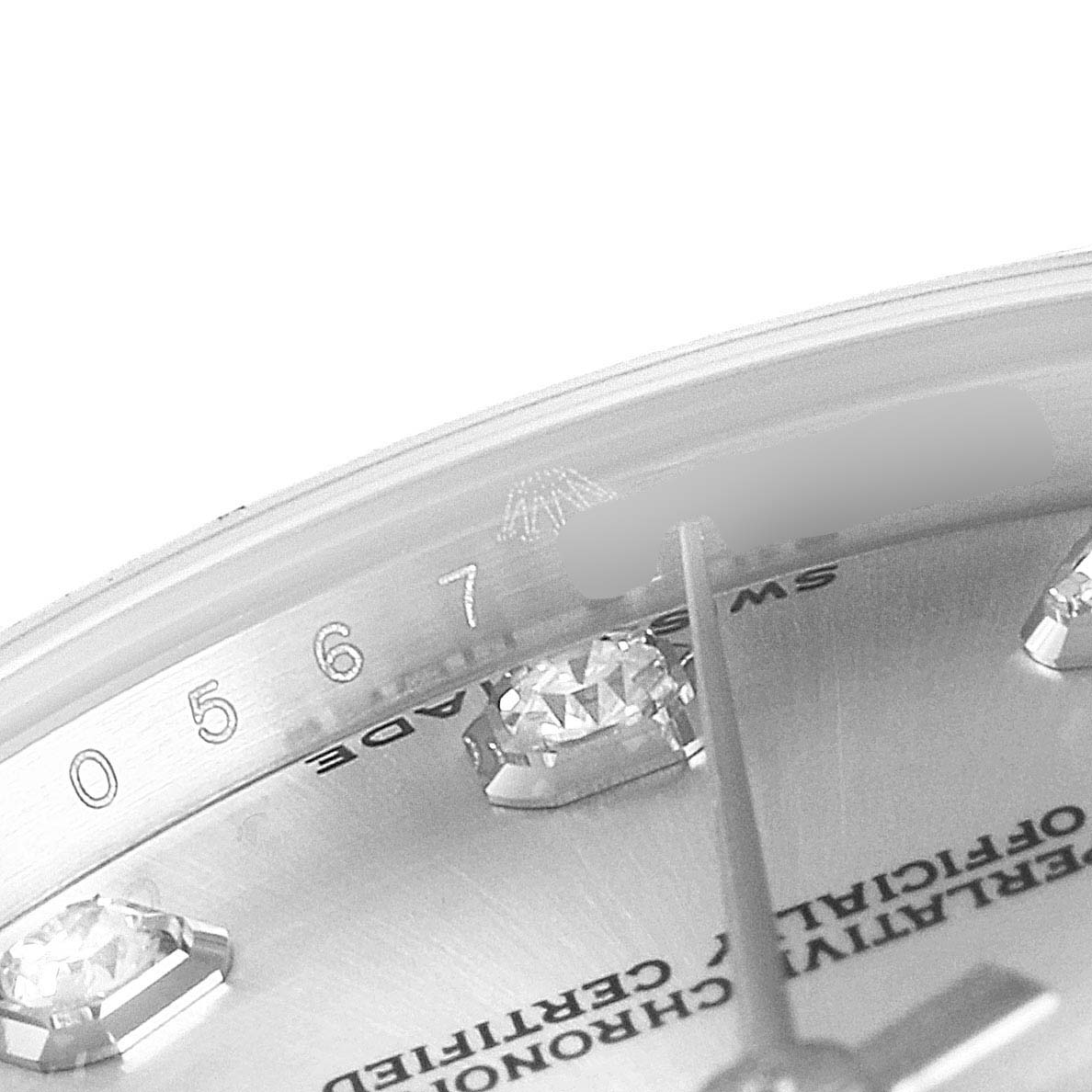 The image shows a close-up of the Rolex Mid-Size 178384 Women
s Stainless Steel Silver Dial 178384 Women
s Stainless Steel Silver Dial watch dial, highlighting the diamond hour markers and partial serial number.