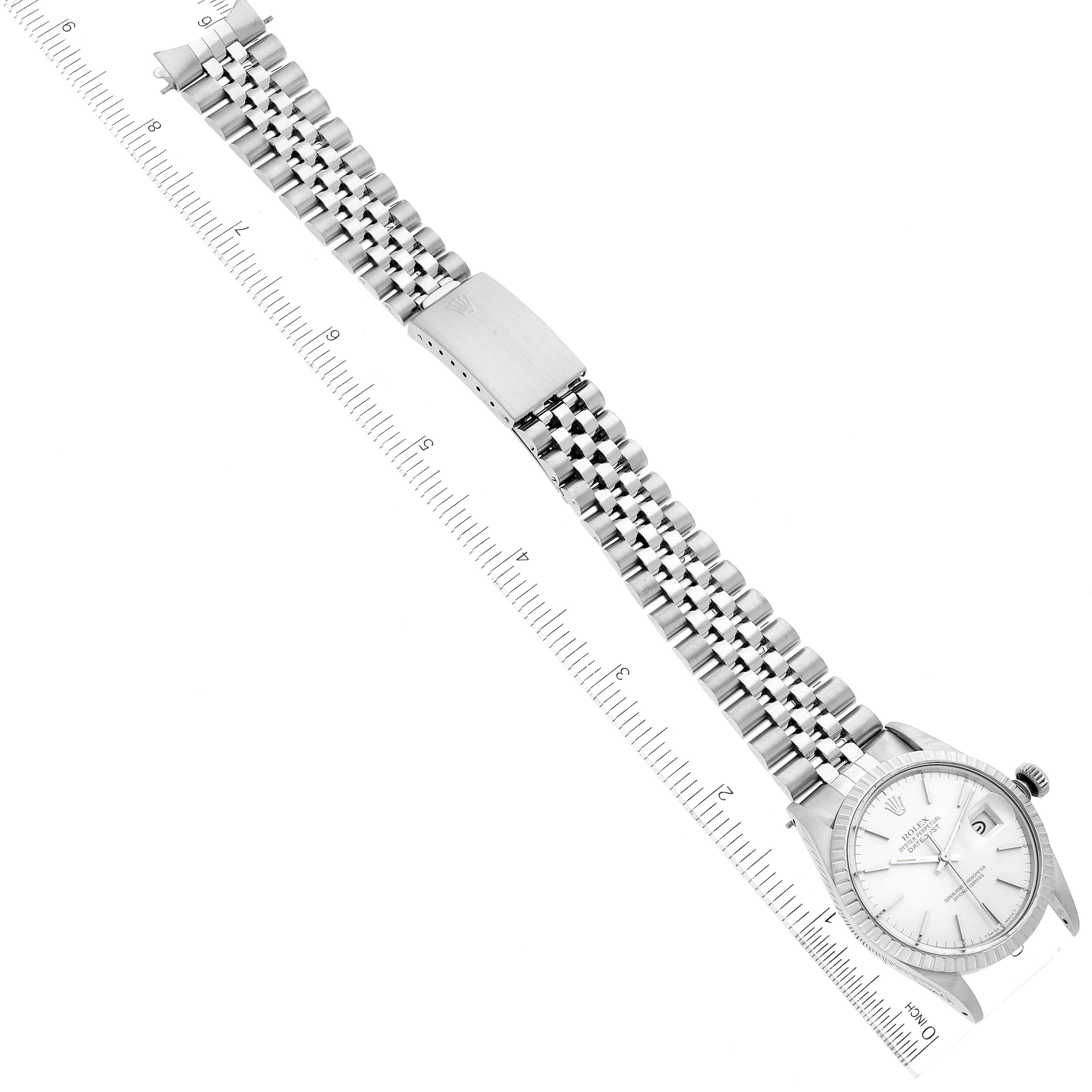 The image shows a straight-on view of a Rolex Vintage Collection 16030 Men
s Stainless Steel Silver Dial 16030 Men
s Stainless Steel Silver Dial watch, including its face, bracelet, and clasp, alongside a ruler.