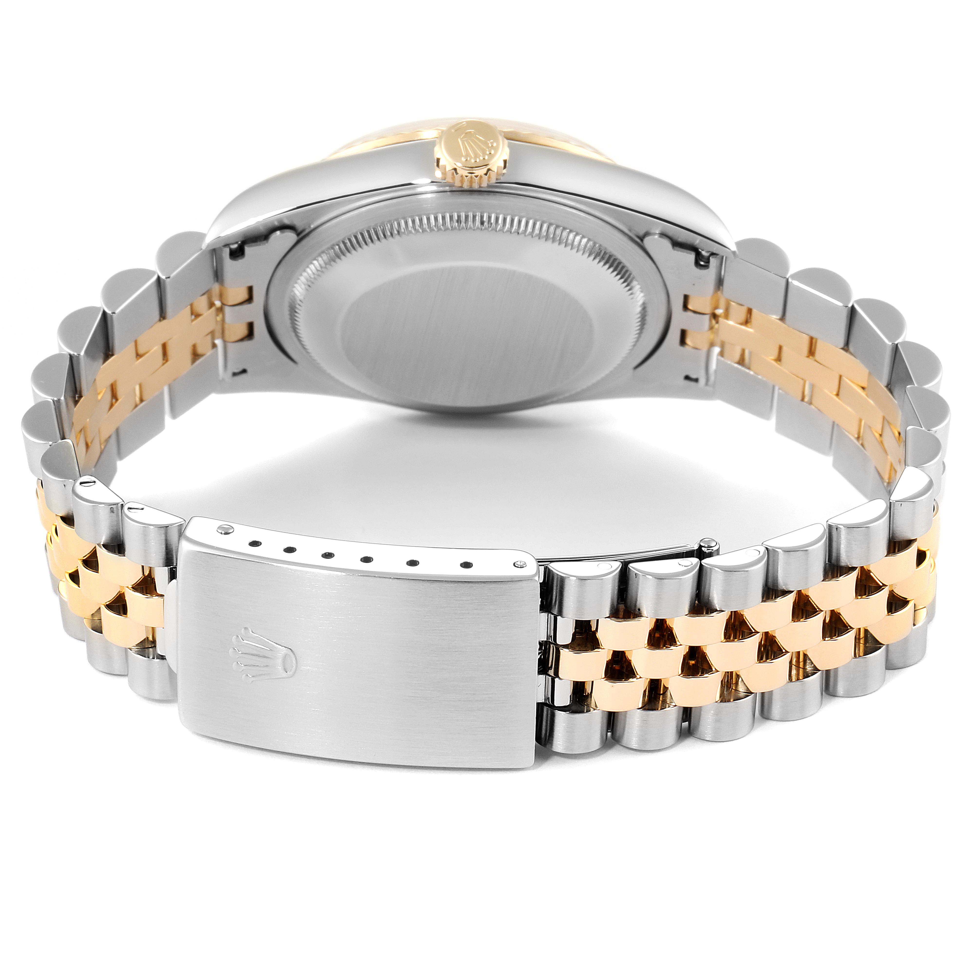 This image shows the back case, crown, and bracelet clasp of a Rolex Datejust 16233 Men's Steel and Gold (two tone) Champagne Dial 16233 Men's Steel and Gold (two tone) Champagne Dial watch.