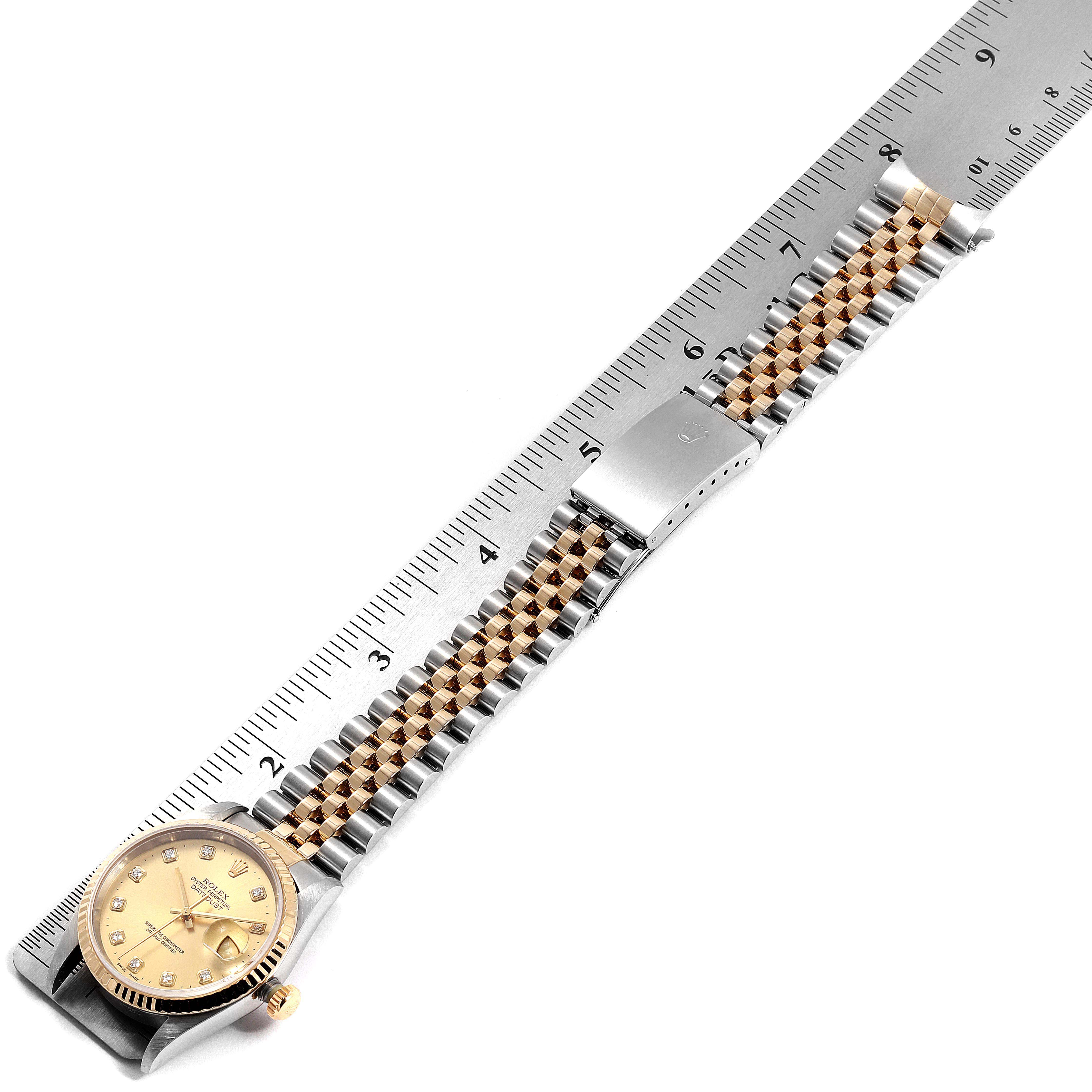 This image shows a Rolex Datejust 16233 Men's Steel and Gold (two tone) Champagne Dial 16233 Men's Steel and Gold (two tone) Champagne Dial watch displayed flat with its jubilee bracelet alongside a ruler for measurement.