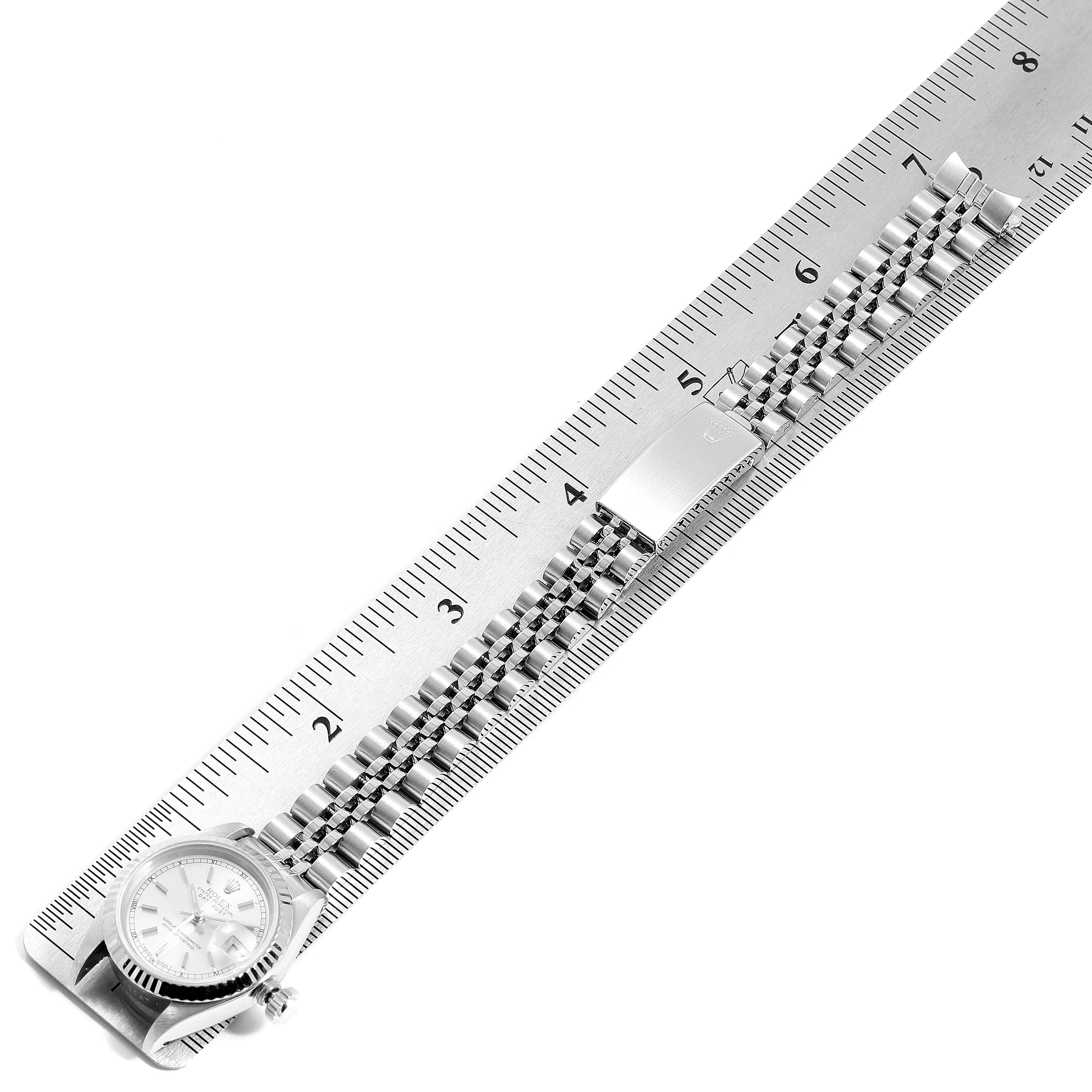 The image shows a Rolex Datejust 69174 Women's Stainless Steel Silver Dial 69174 Women's Stainless Steel Silver Dial watch laid flat against a ruler, displaying the full bracelet, clasp, and watch face.