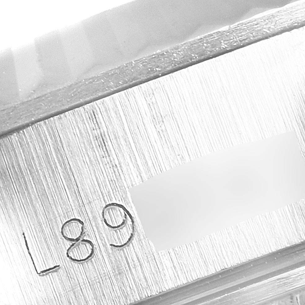 This image shows a close-up of the serial number engraving on the case of a Rolex Datejust 69174 Women's Stainless Steel Silver Dial 69174 Women's Stainless Steel Silver Dial watch.