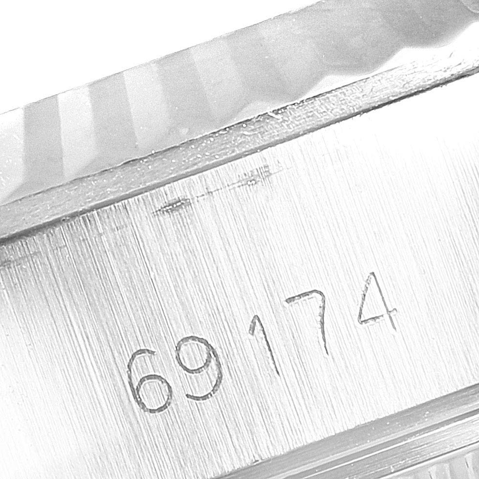 This image shows a close-up of the engraved serial number "69174" on the case of a Rolex Datejust 69174 Women's Stainless Steel Silver Dial 69174 Women's Stainless Steel Silver Dial watch.