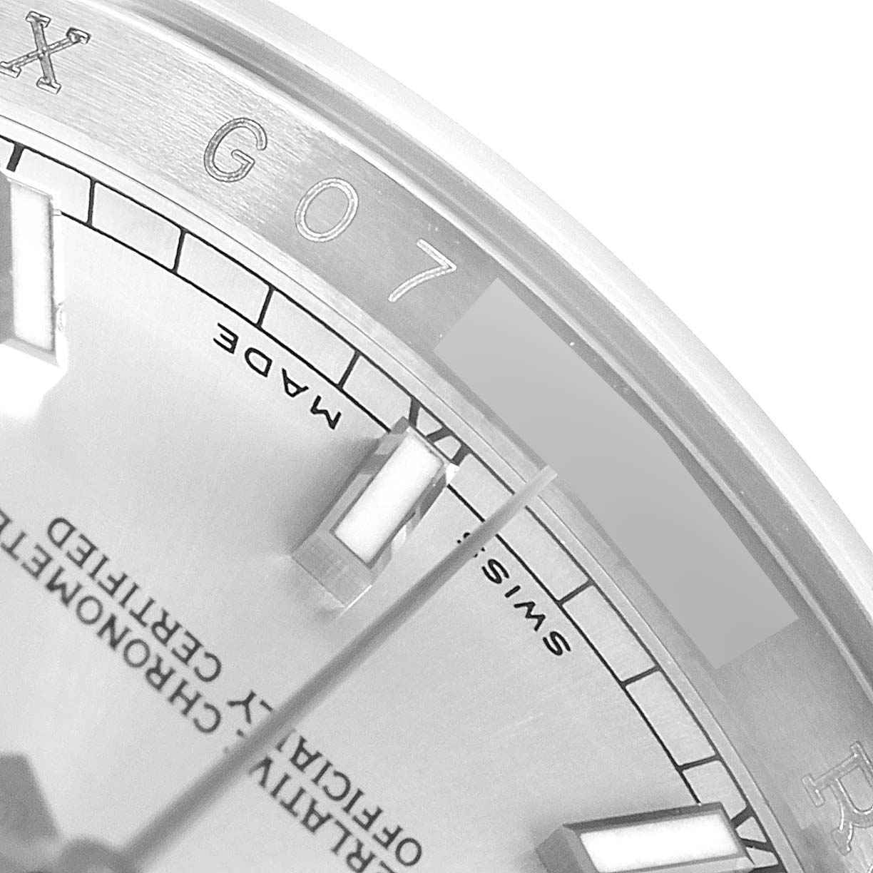 Close-up angle of a Rolex Datejust 116234 Men's Stainless Steel Silver Dial 116234 Men's Stainless Steel Silver Dial watch showing part of the dial, hour markers, and edge of the bezel.