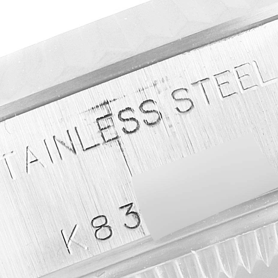 The image shows a close-up of the stainless steel case and serial number of a Rolex Datejust 79174 Women
s Stainless Steel Silver Dial 79174 Women
s Stainless Steel Silver Dial watch.