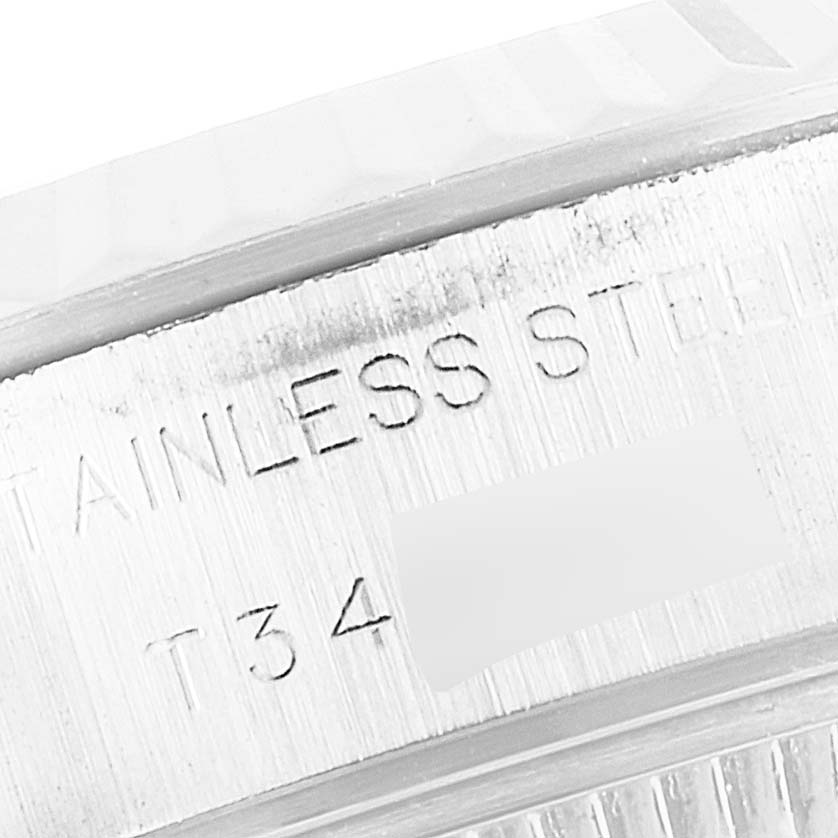 The image shows an up-close view of the side engraving on a Rolex Datejust 69174 Women
s Stainless Steel Silver Dial 69174 Women
s Stainless Steel Silver Dial watch, highlighting its stainless steel material.