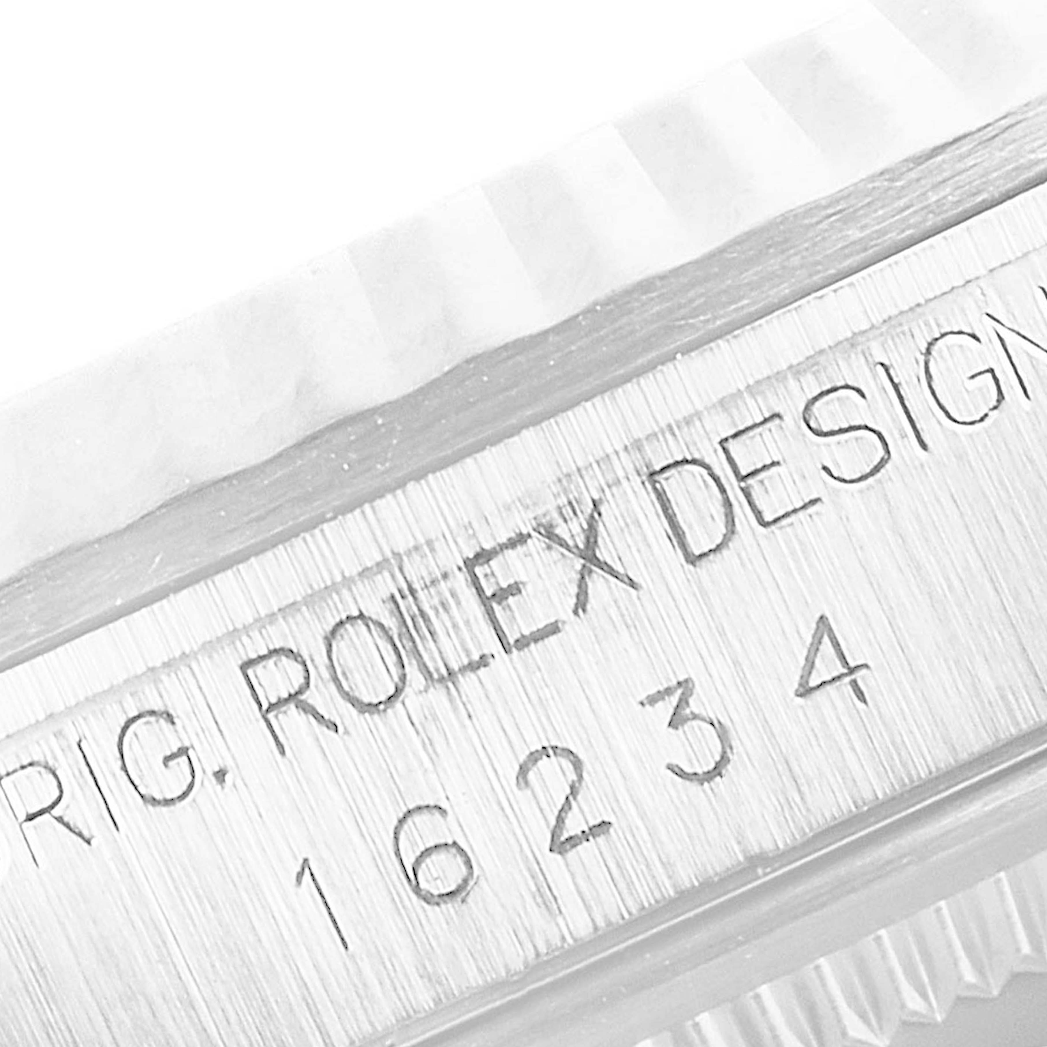 This image shows the side engraving of a Rolex Datejust 16234 Men's Stainless Steel White Dial 16234 Men's Stainless Steel White Dial watch, highlighting the model number 16234 and the "Rolex Design" inscription.