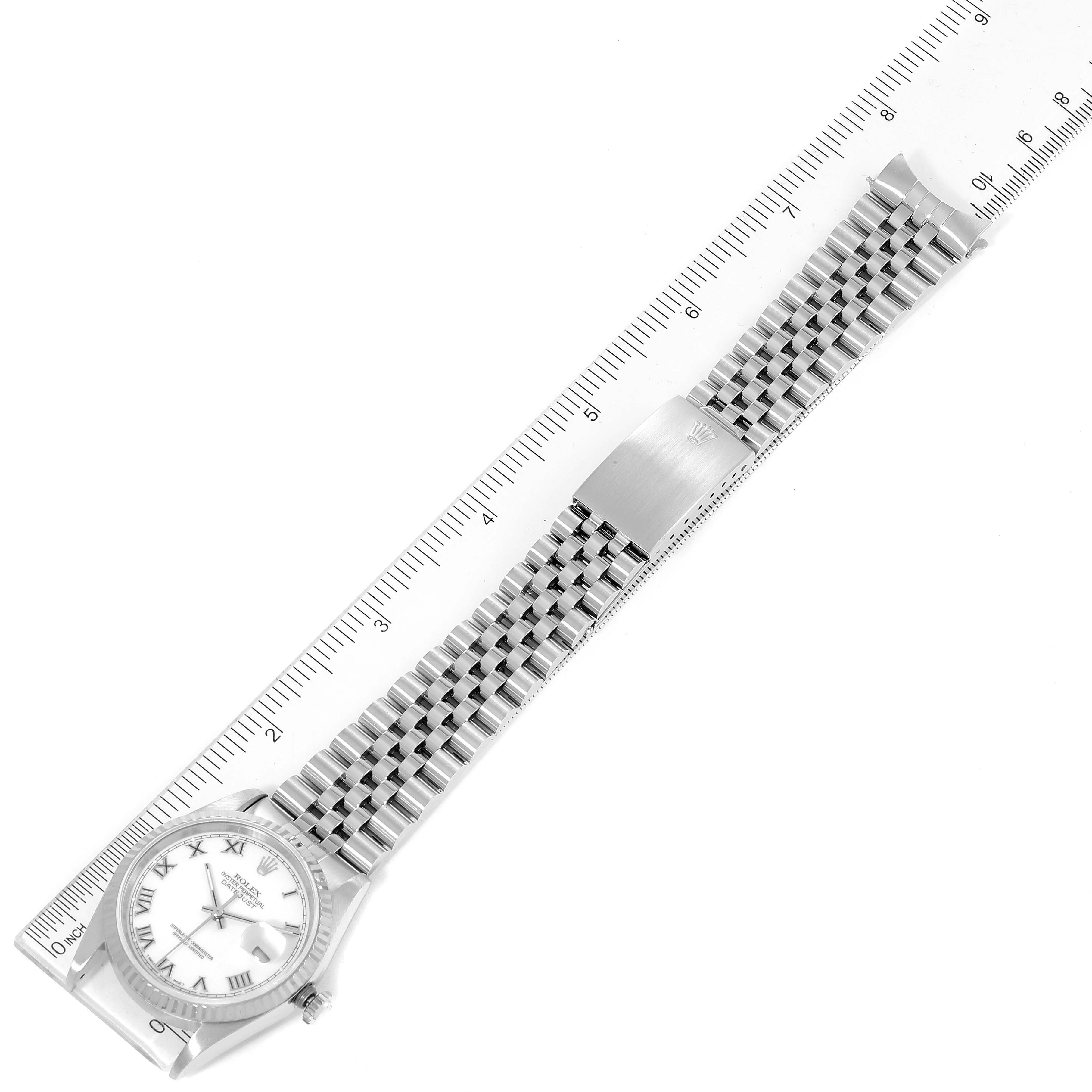 This image shows a Rolex Datejust 16234 Men's Stainless Steel White Dial 16234 Men's Stainless Steel White Dial watch laid flat, highlighting the face, bracelet, and clasp against a ruler for scale.